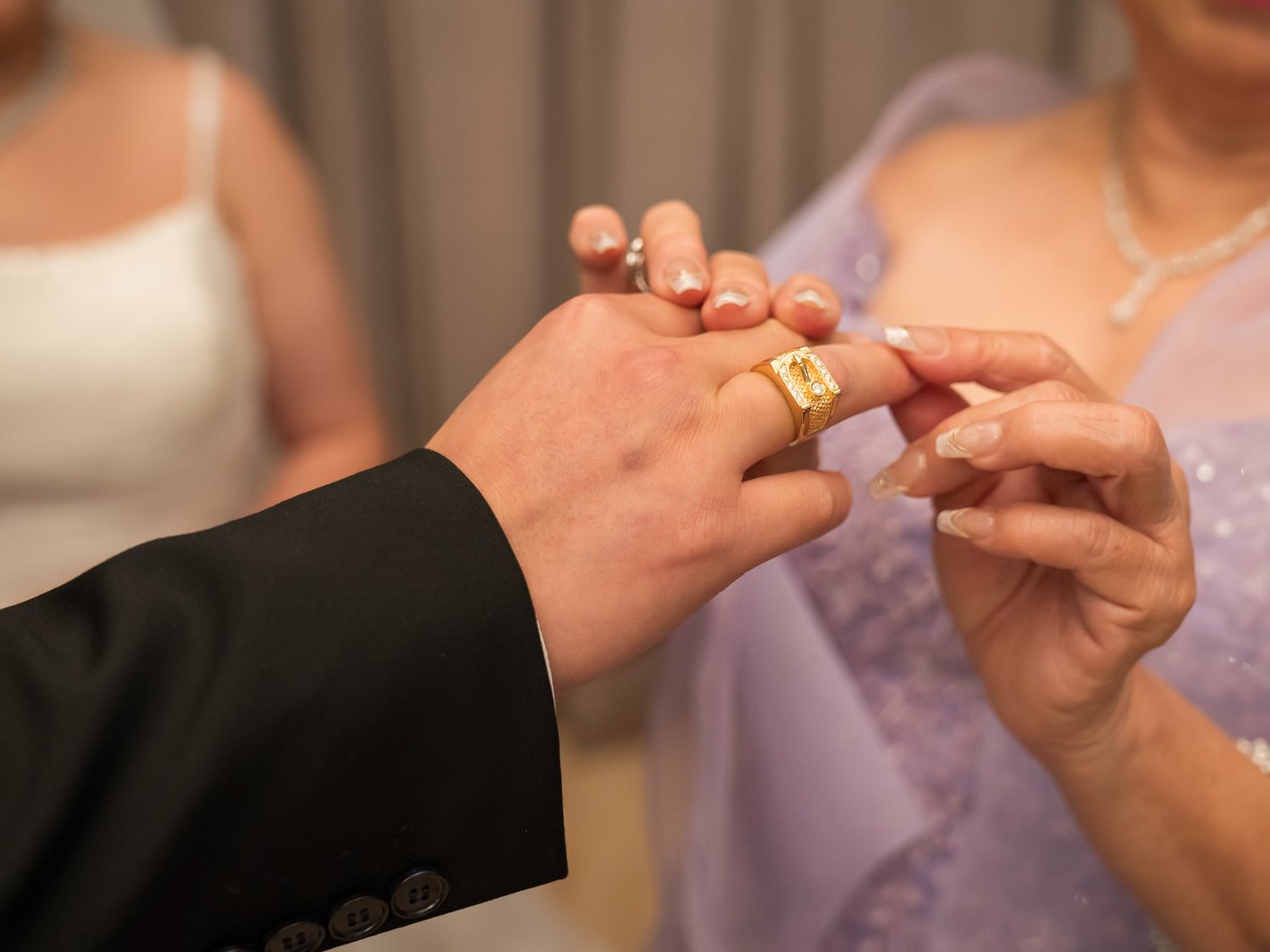 Close-up of a ring being placed on a finger