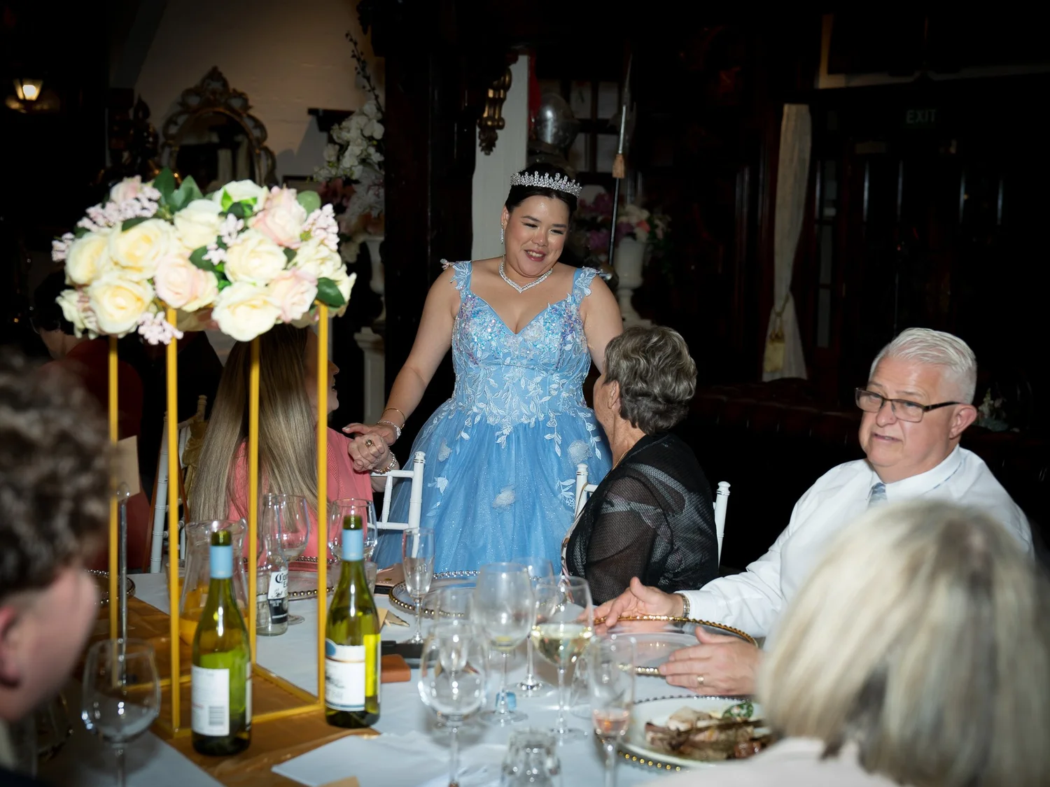 Stephanie greets guests at their table