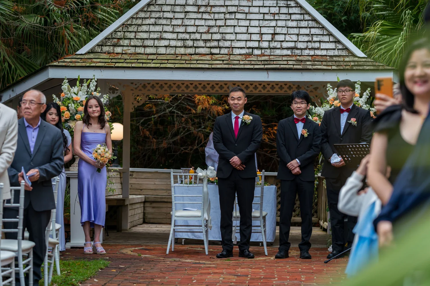 Jankai and his groomsmen wait in front of the gazebo