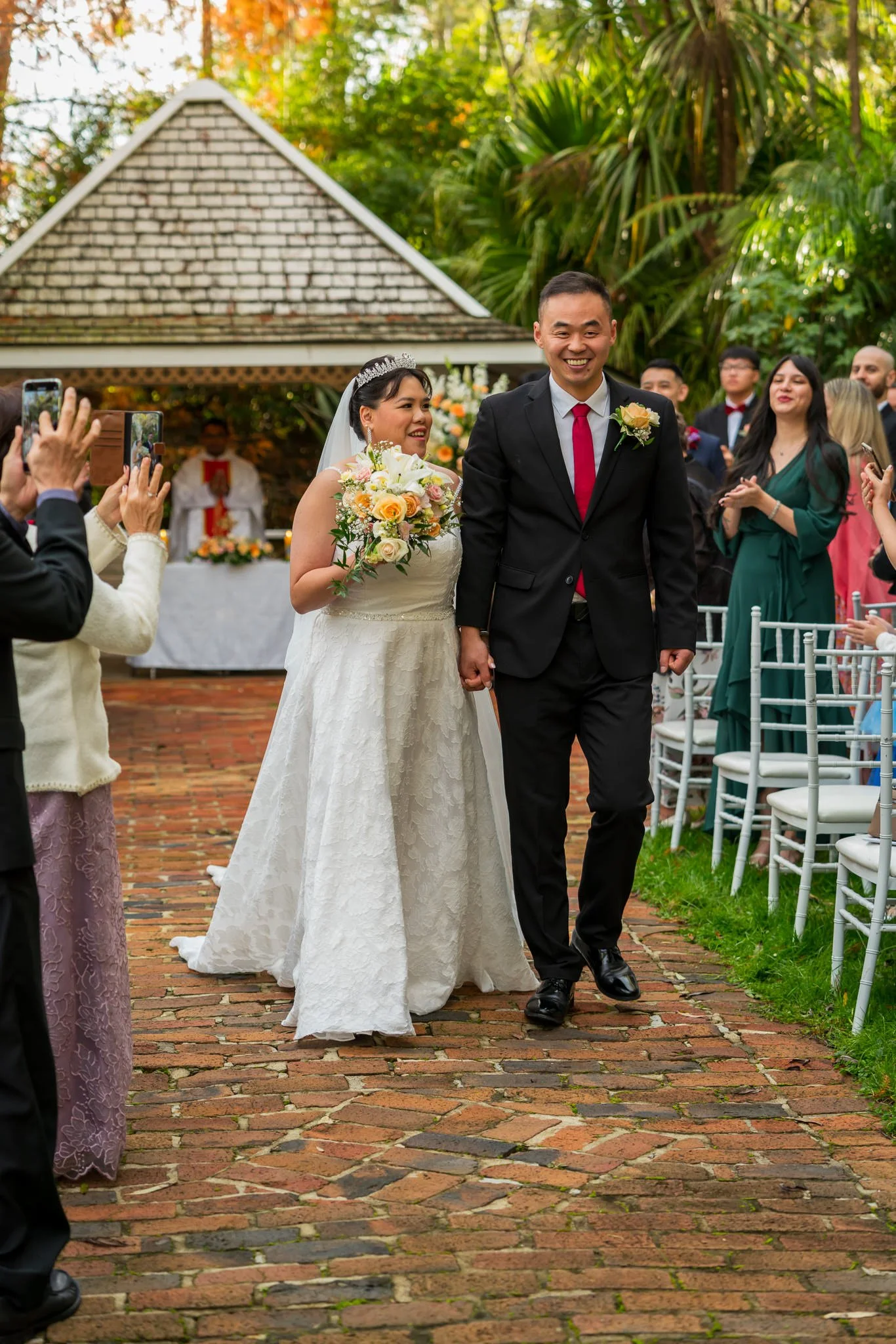 Stephanie and Jankai walk back down the brick aisle