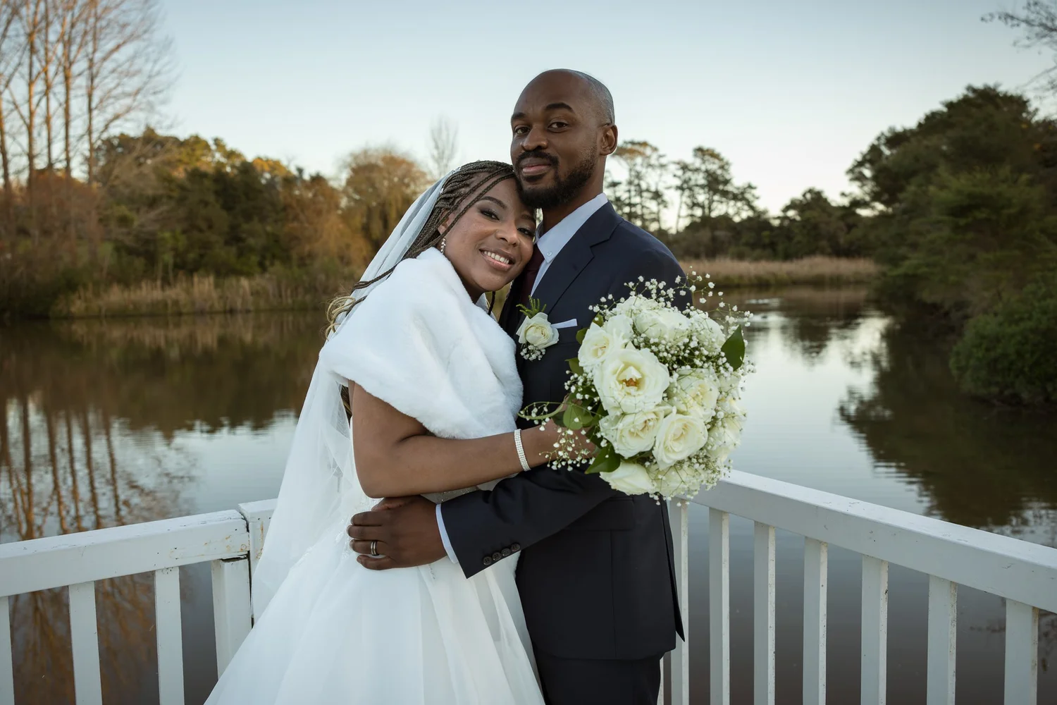 Chiedza and Foster hug by the lake at sunset
