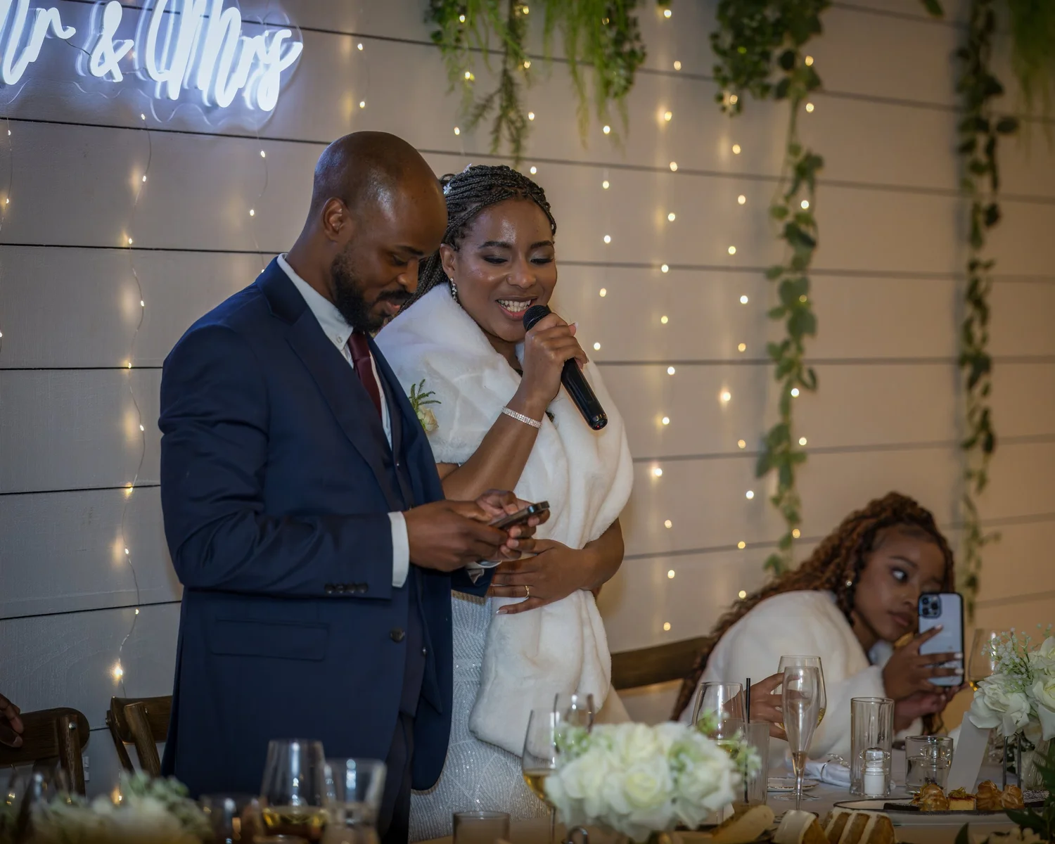 Chiedza and Foster speak to their guests at the reception