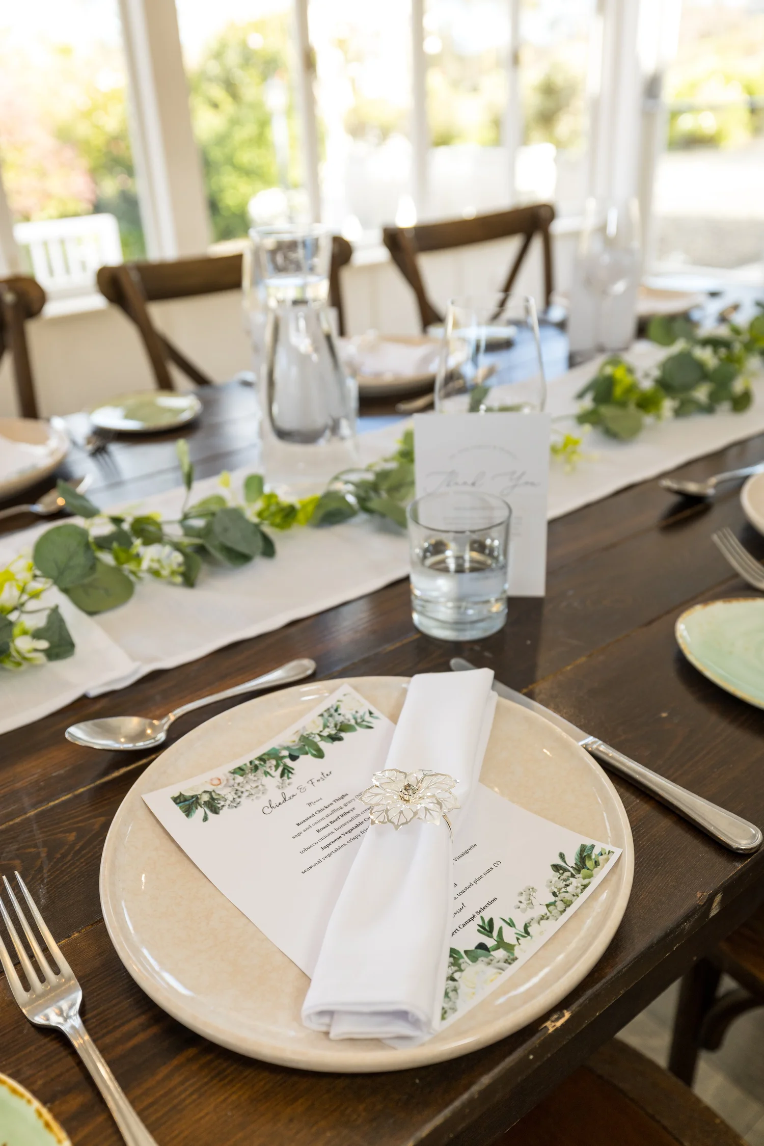 A menu tucked into a napkin on a reception table