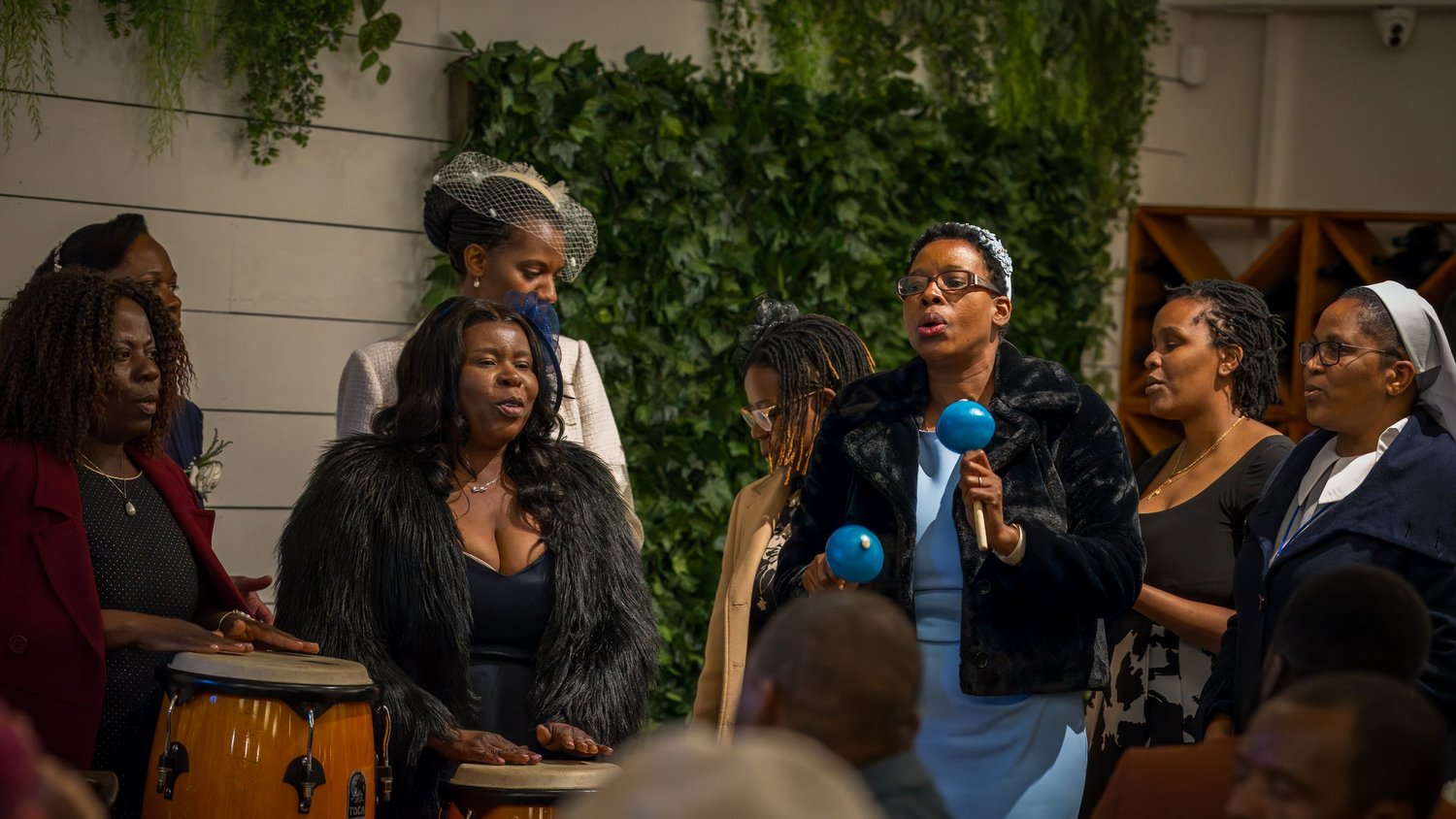 Guests sing and play drums during the celebration