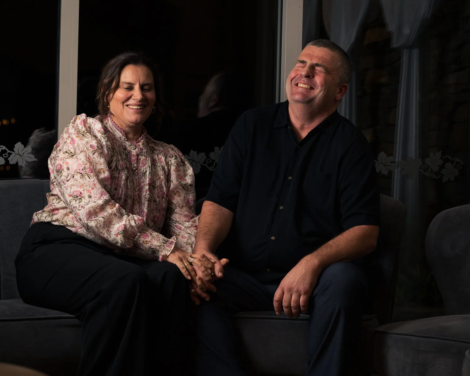 Two guests laugh together for an evening portrait