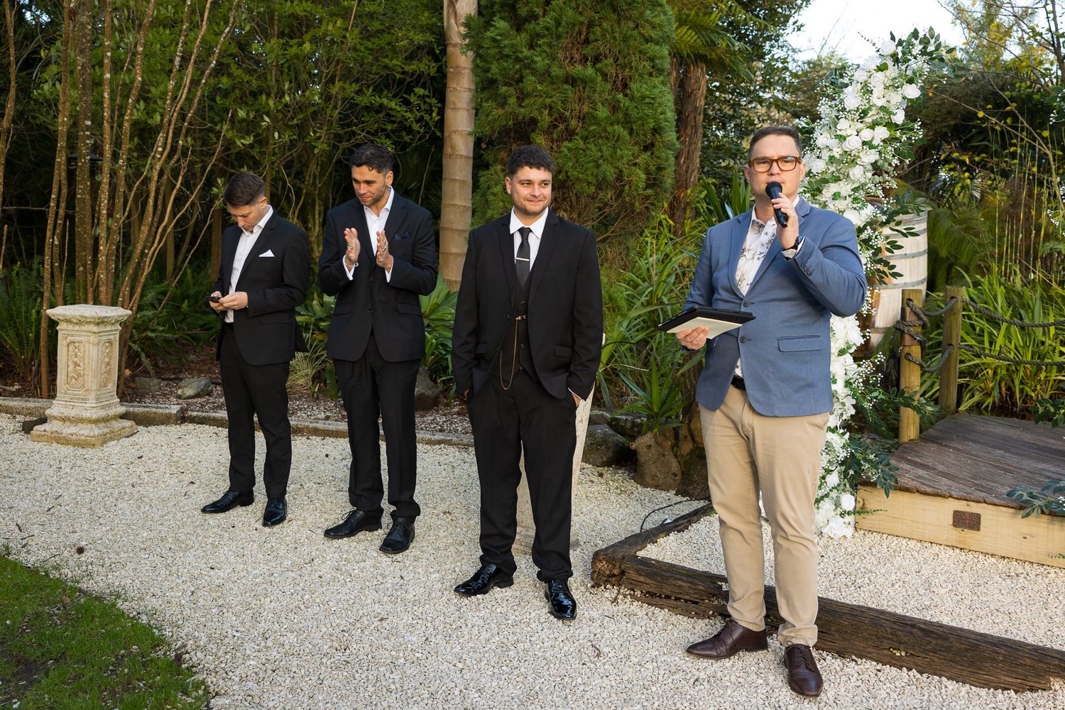 Connor and his groomsmen wait in the garden as the celebrant speaks