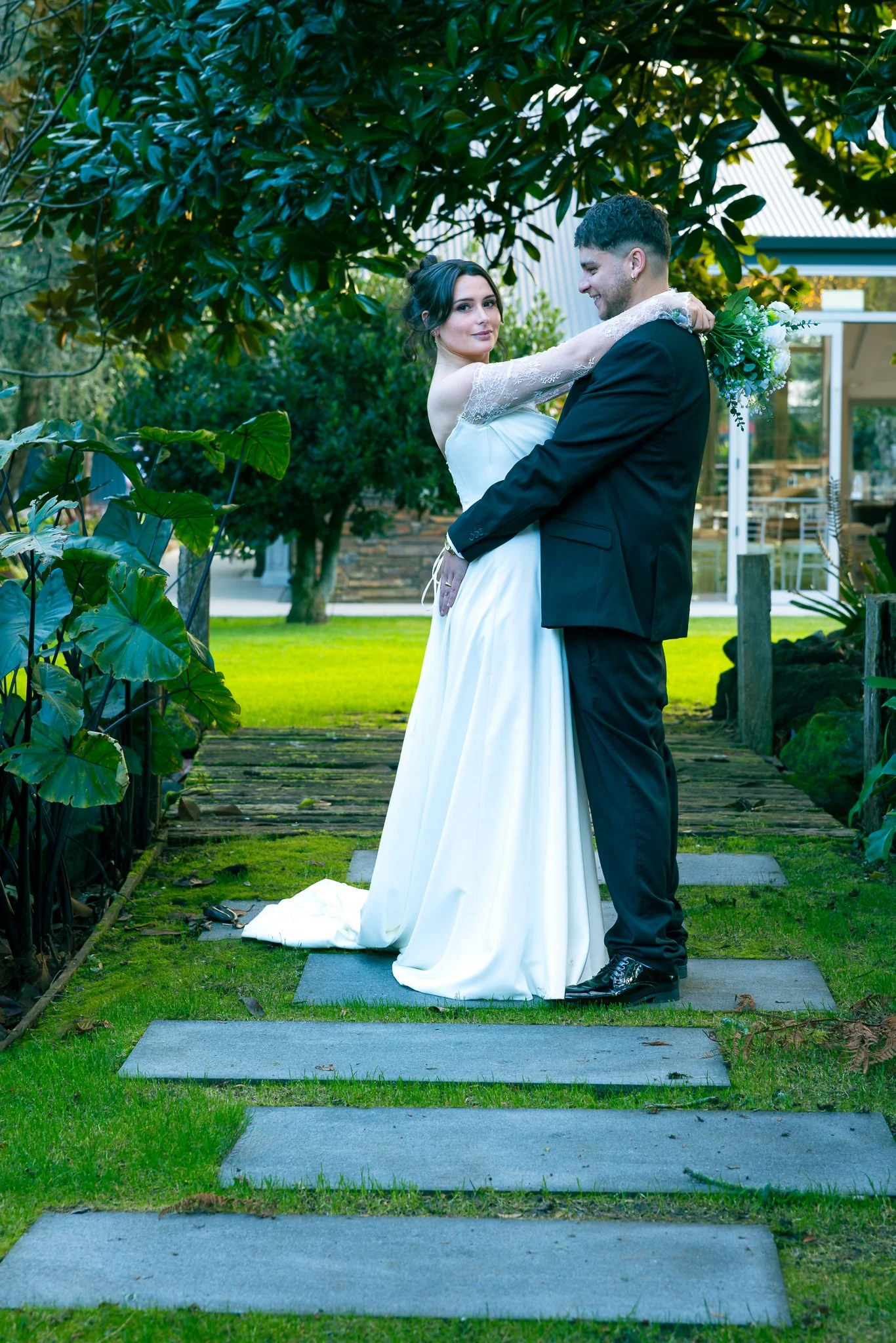 Paige and Connor embrace on a stepping-stone path
