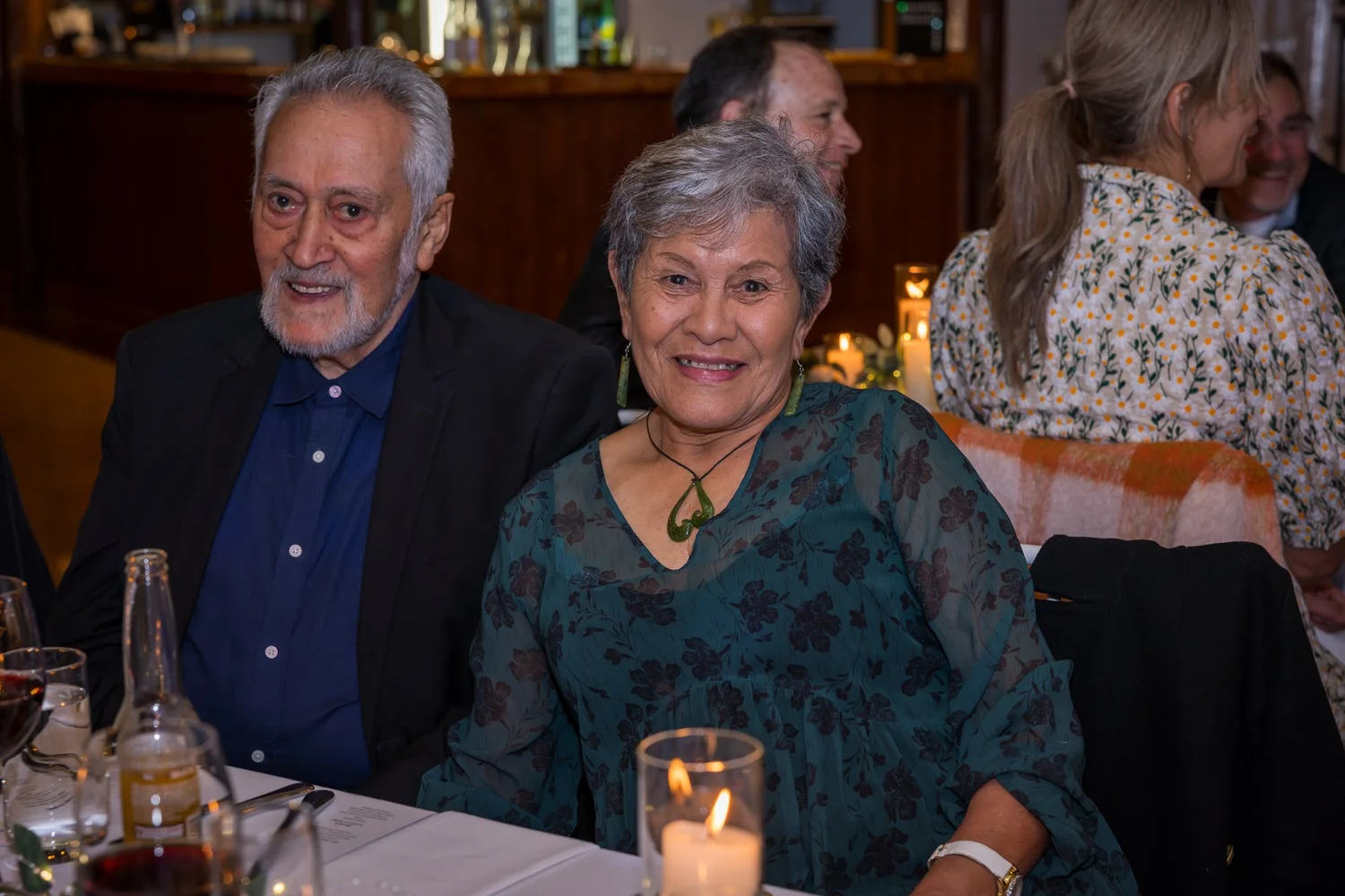 Two guests smile at their table
