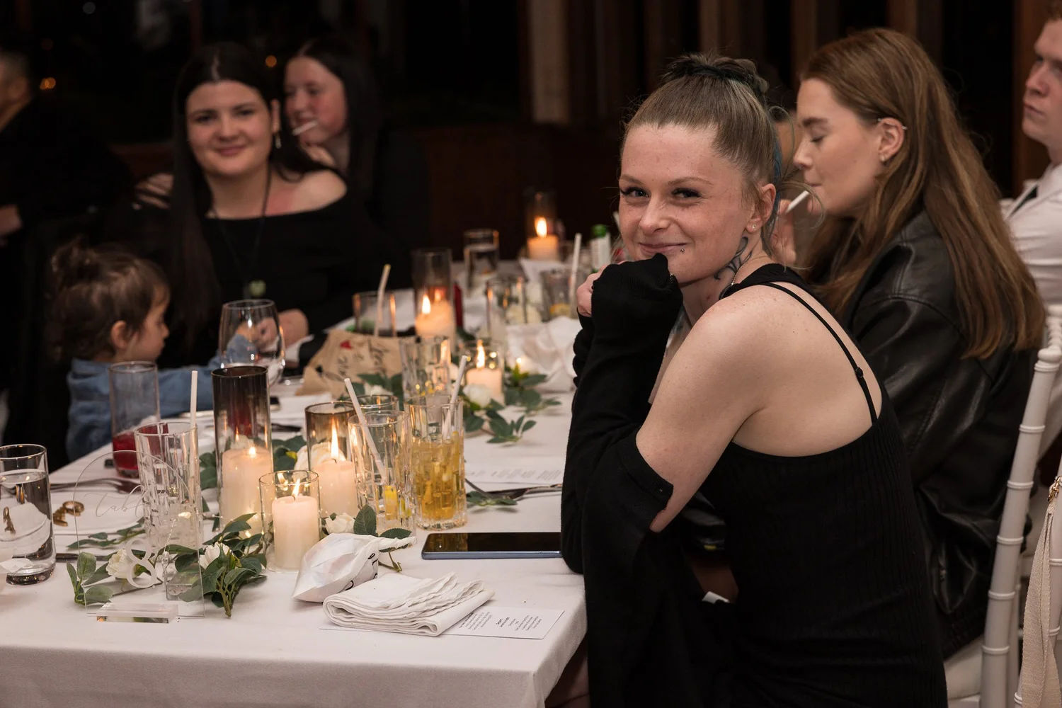 Guests chat and laugh at the reception table