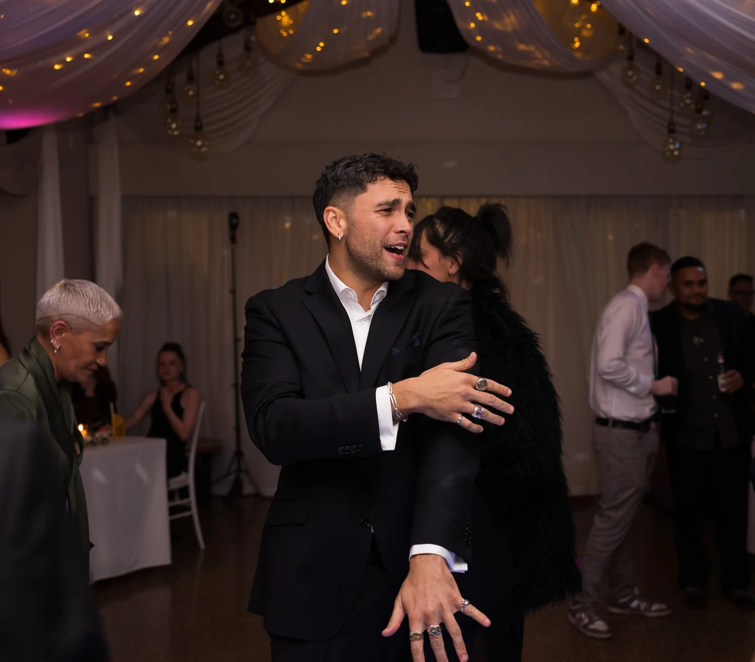 A groomsman dances on the dance floor