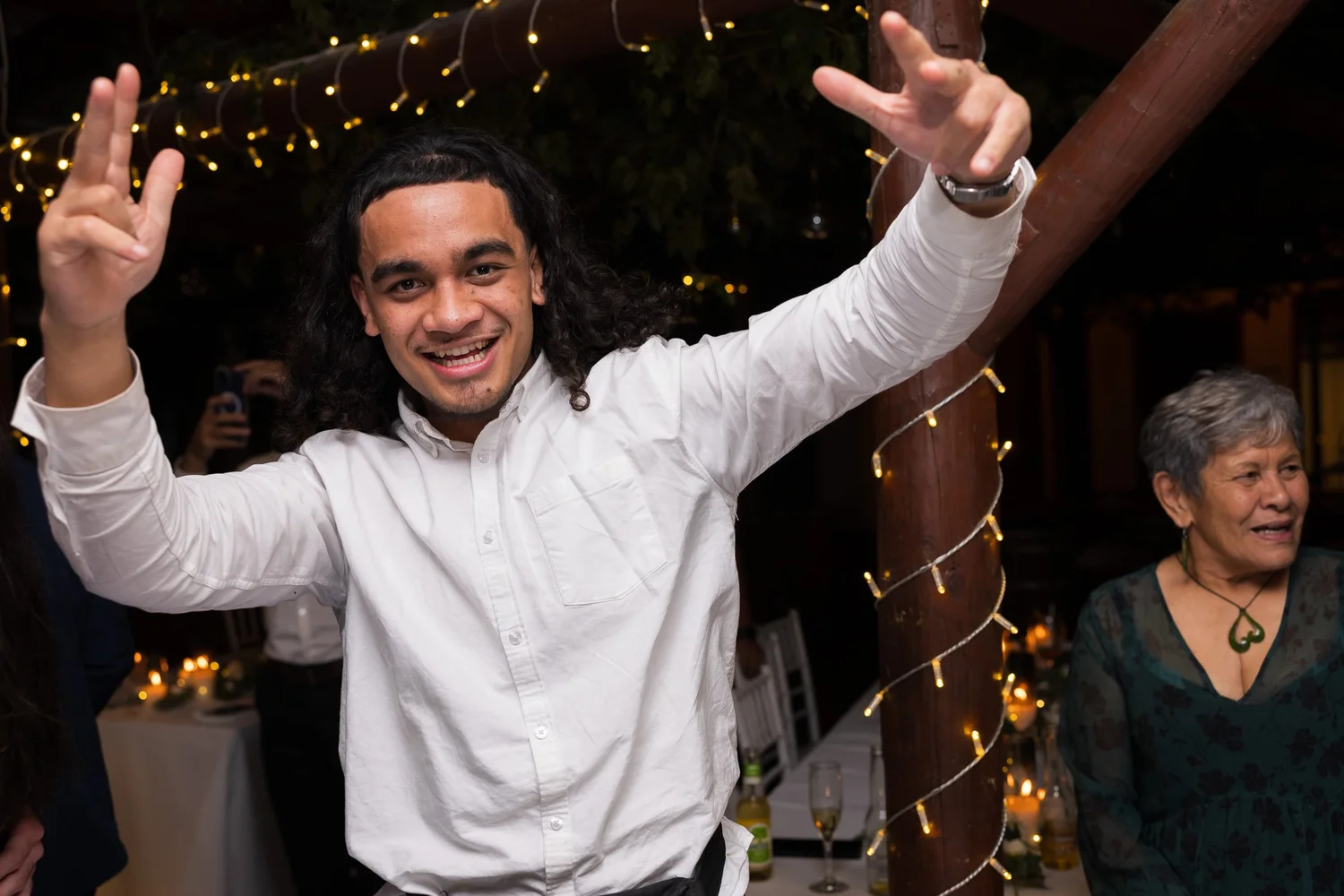A guest throws his arms in the air while dancing