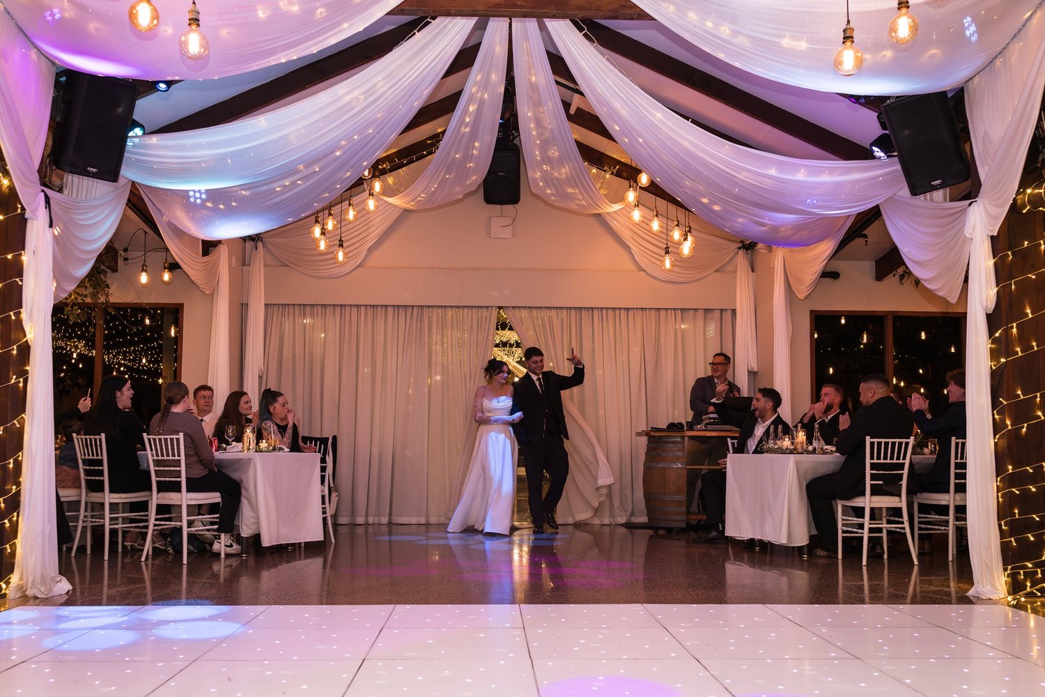Paige and Connor's first dance under draped fabric and lights