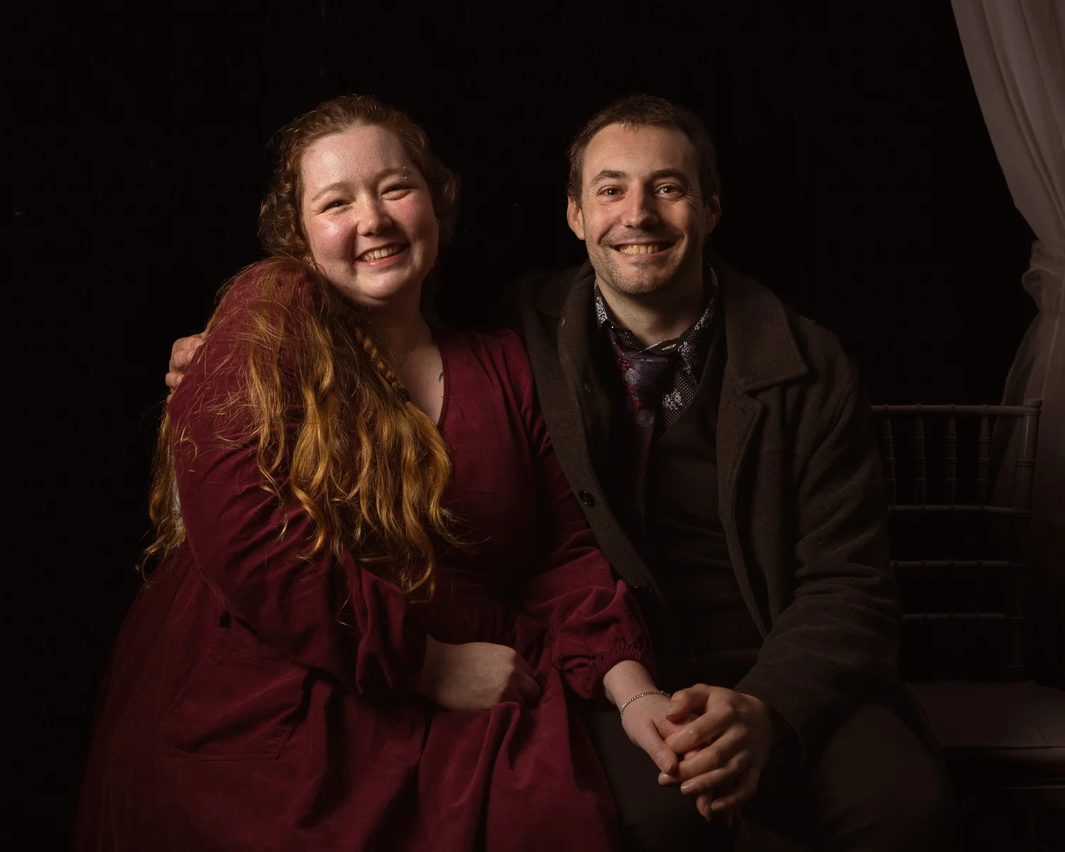 Two guests smile for a portrait