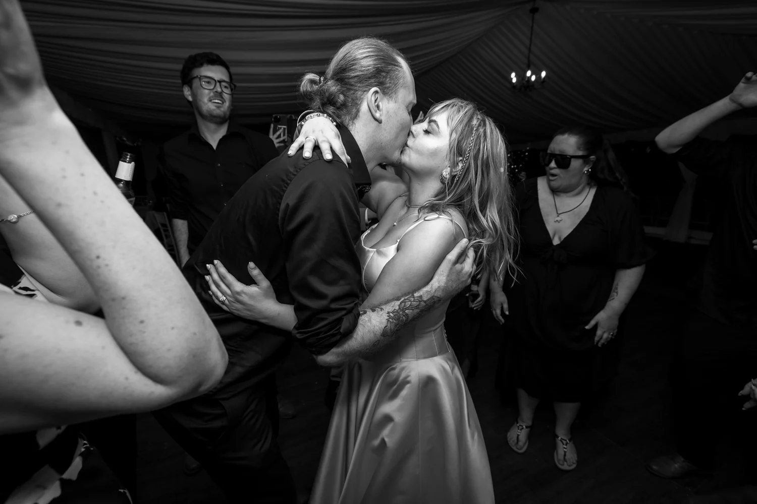 Black and white photo of Shannon and Connor kissing on the dance floor