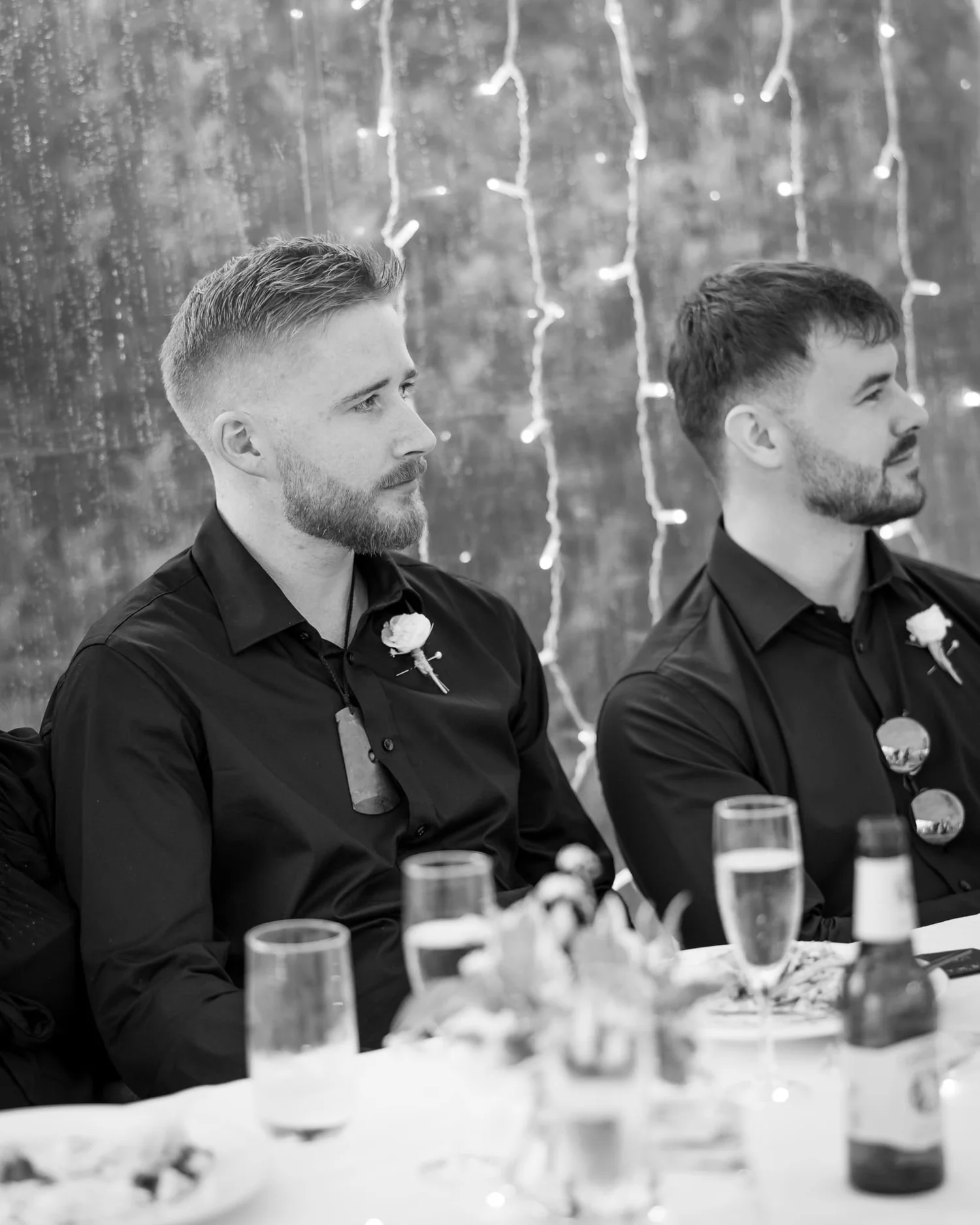 Black and white photo of two groomsmen at the table