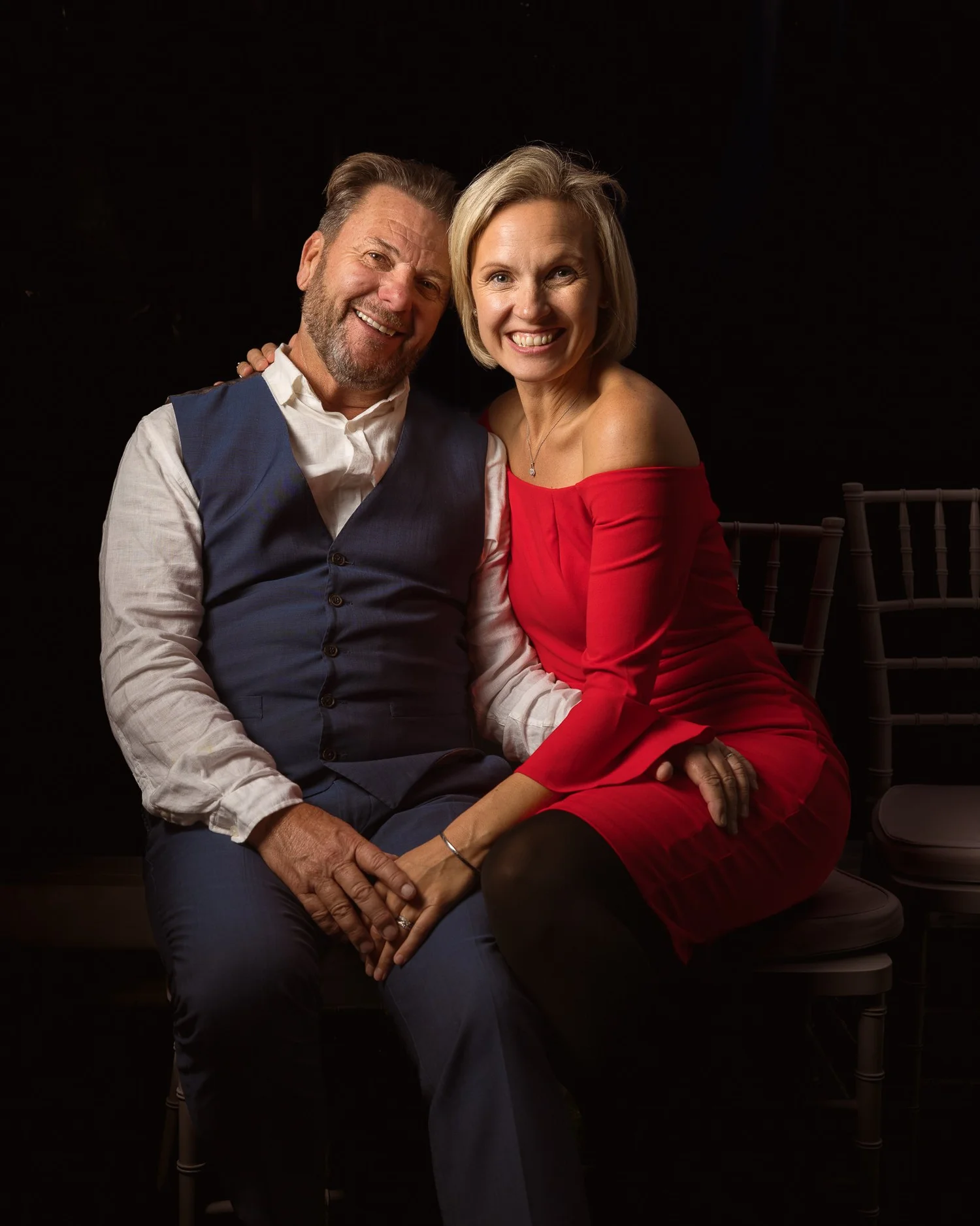 Two guests smile together for an evening portrait
