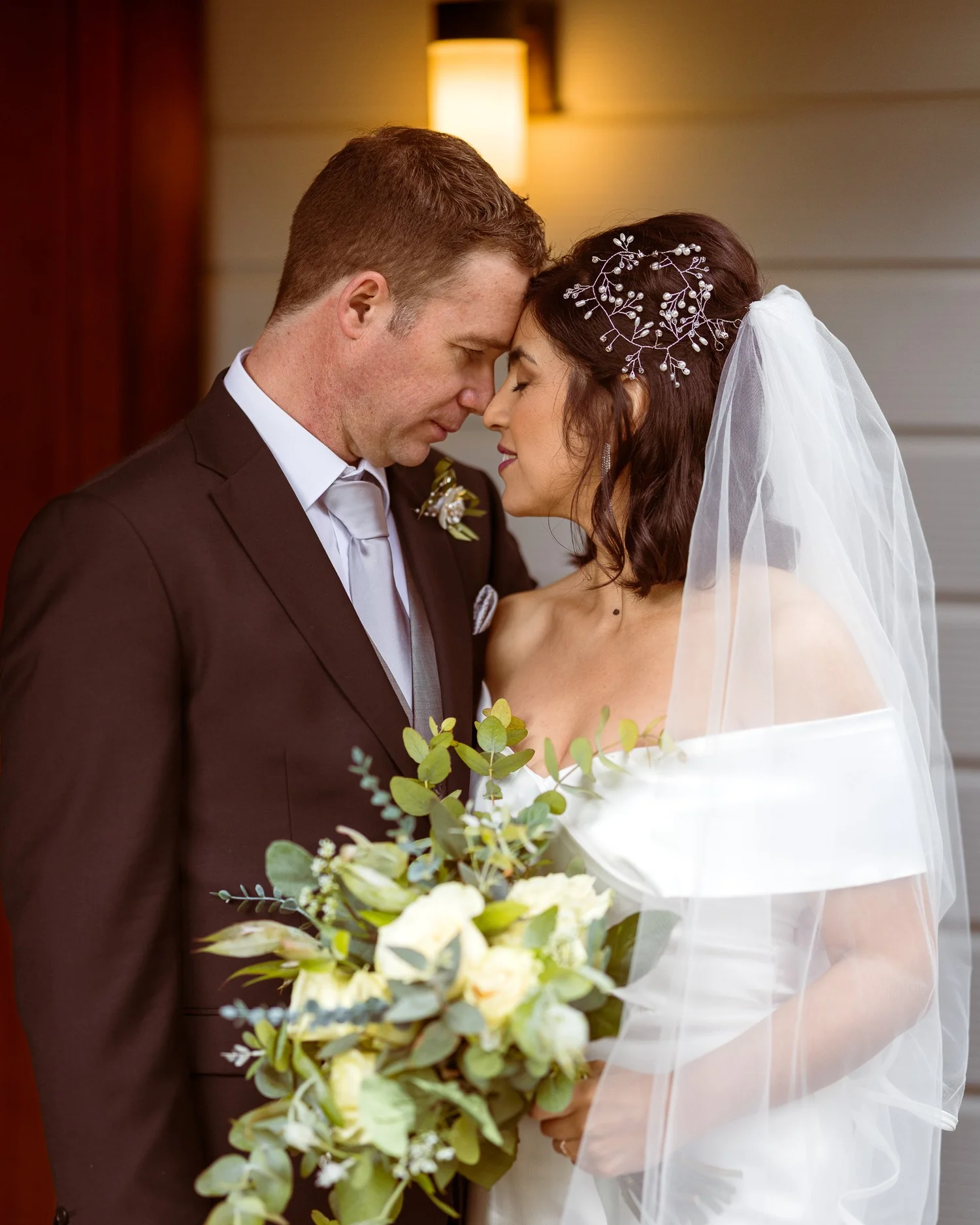 Feby and Steven touch foreheads on the veranda