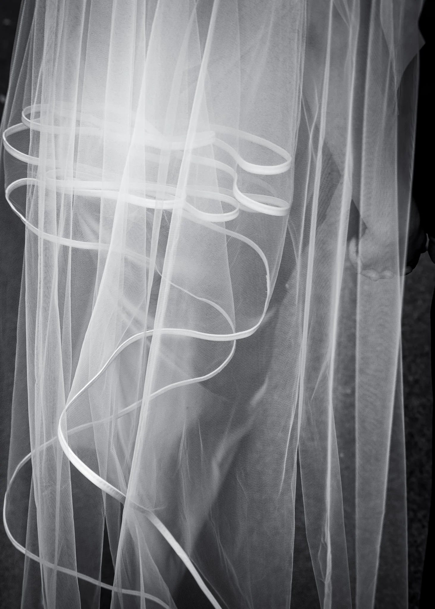 Black and white close-up of the ribbon edge of Feby's veil