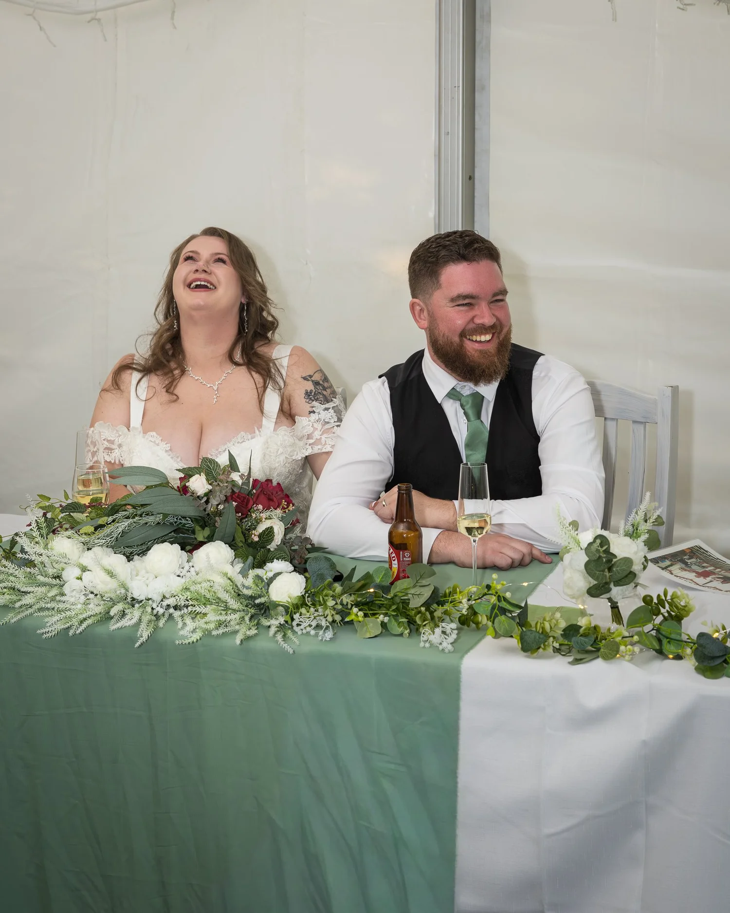 Janine and Kyle laugh at the head table