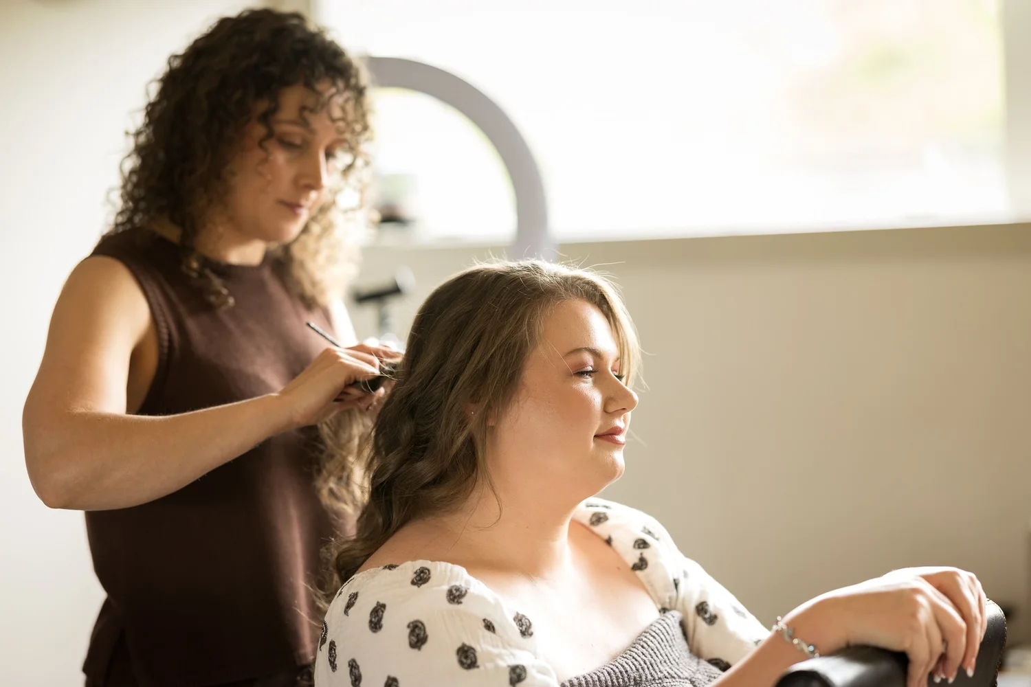 Janine has her hair styled during bridal preparations