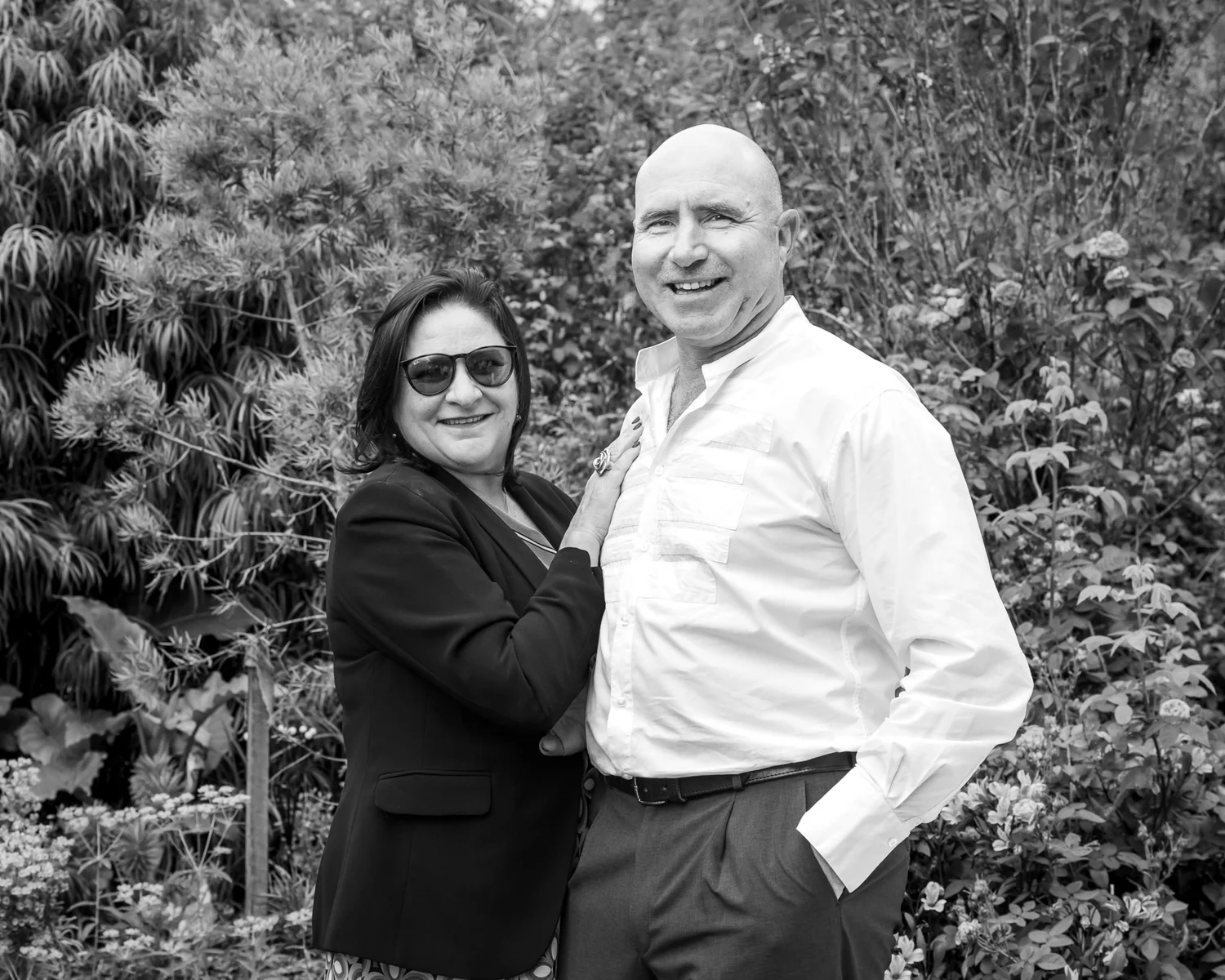 Black and white photo of two guests posing in the garden