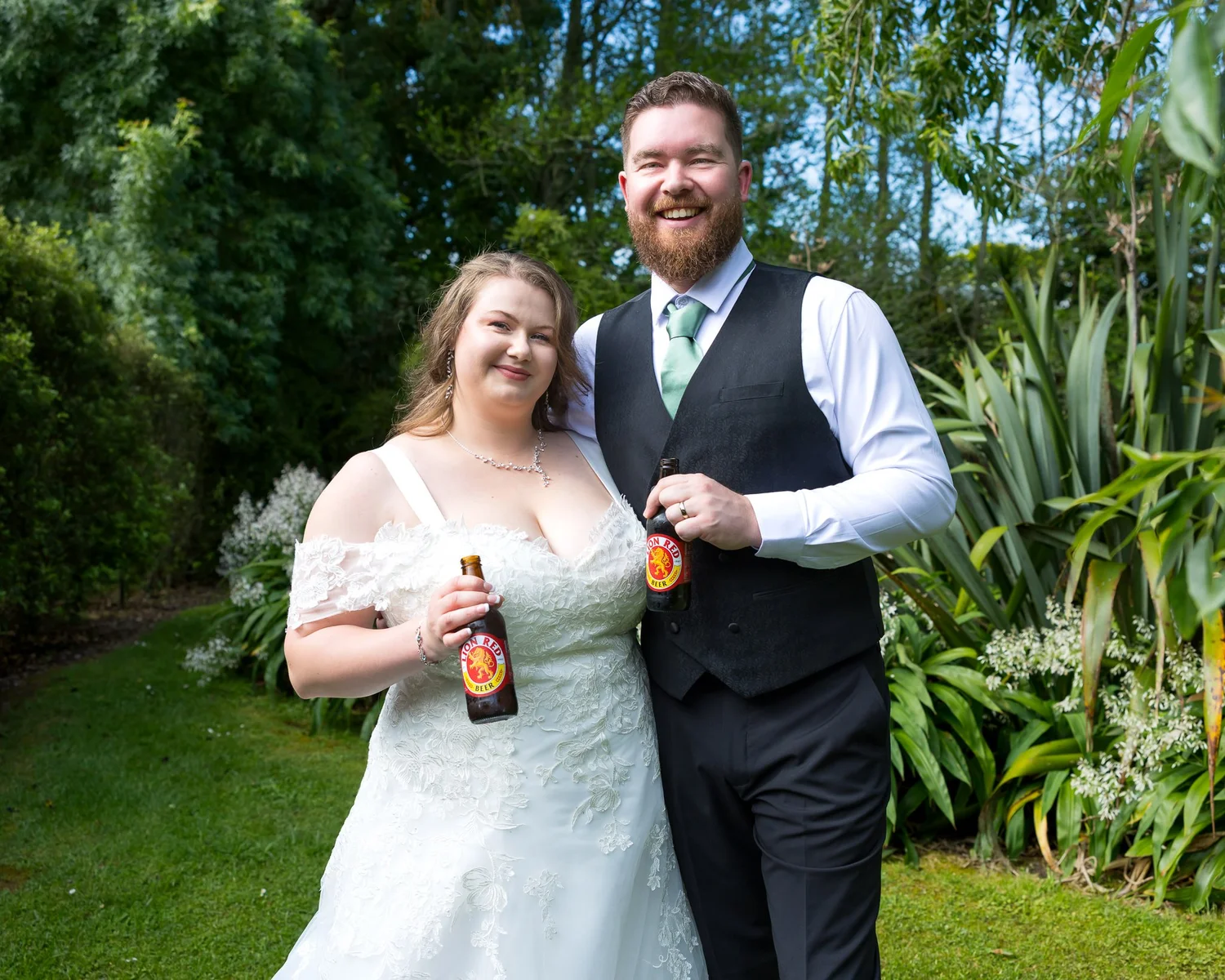 Janine and Kyle laugh together holding drinks