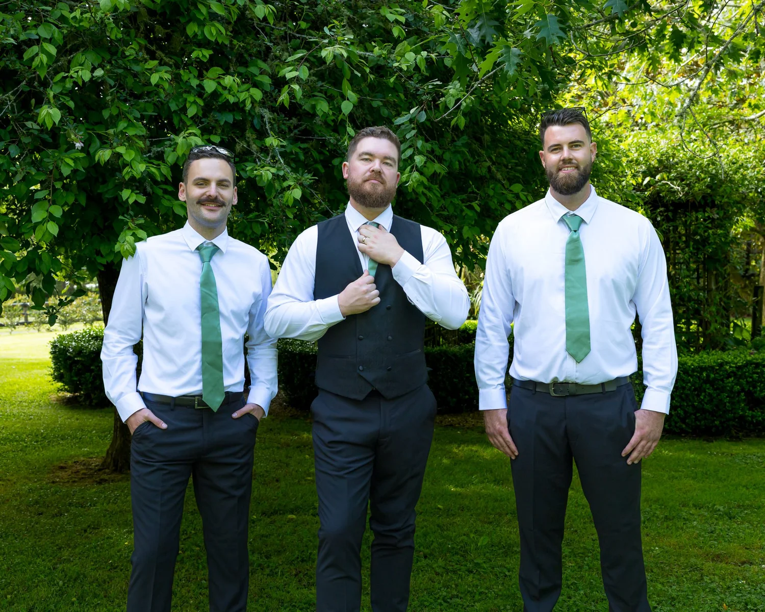 Kyle with two groomsmen in the garden