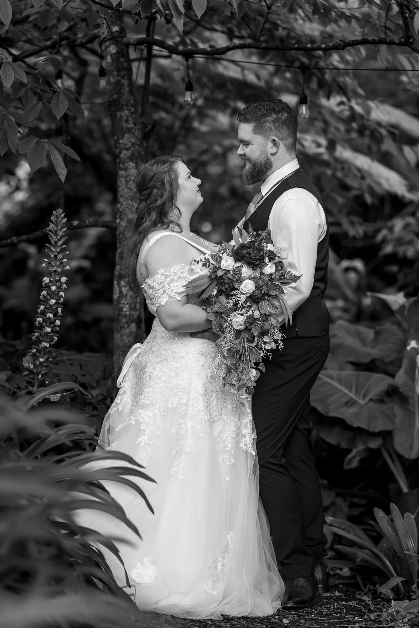 Black and white photo of Janine and Kyle among tall plants