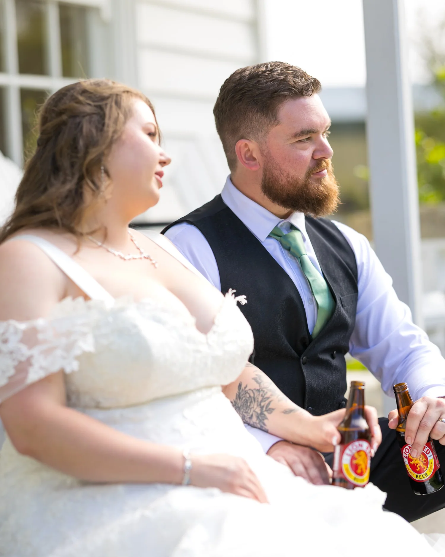 Janine and Kyle sit together with drinks in hand