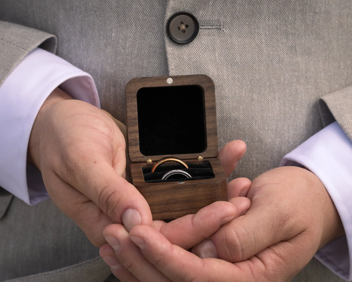 Nick holds the rings in a small wooden box