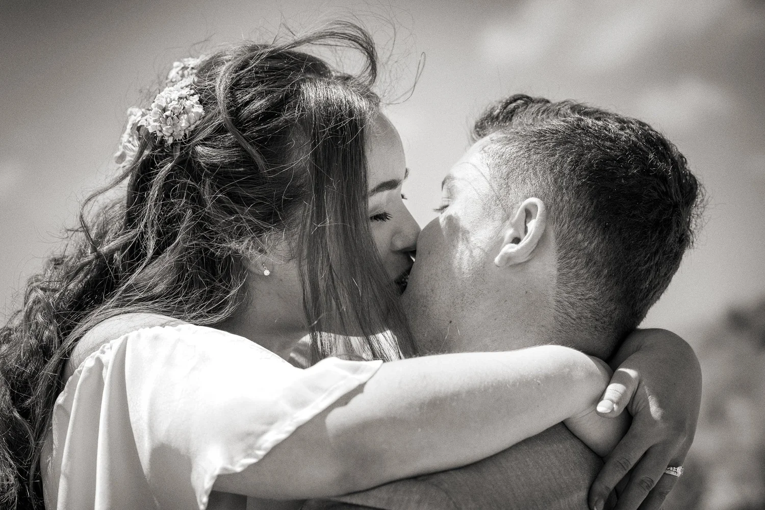 Black and white close-up of Cerise and Nick kissing