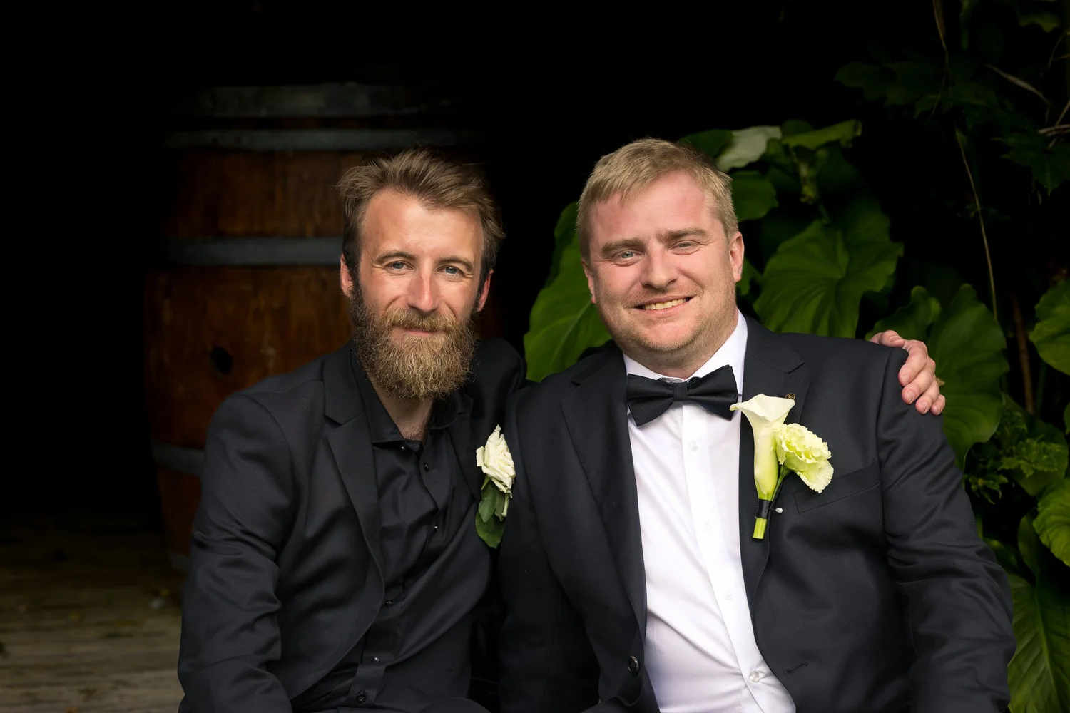 Warwick with a groomsman in front of a wine barrel