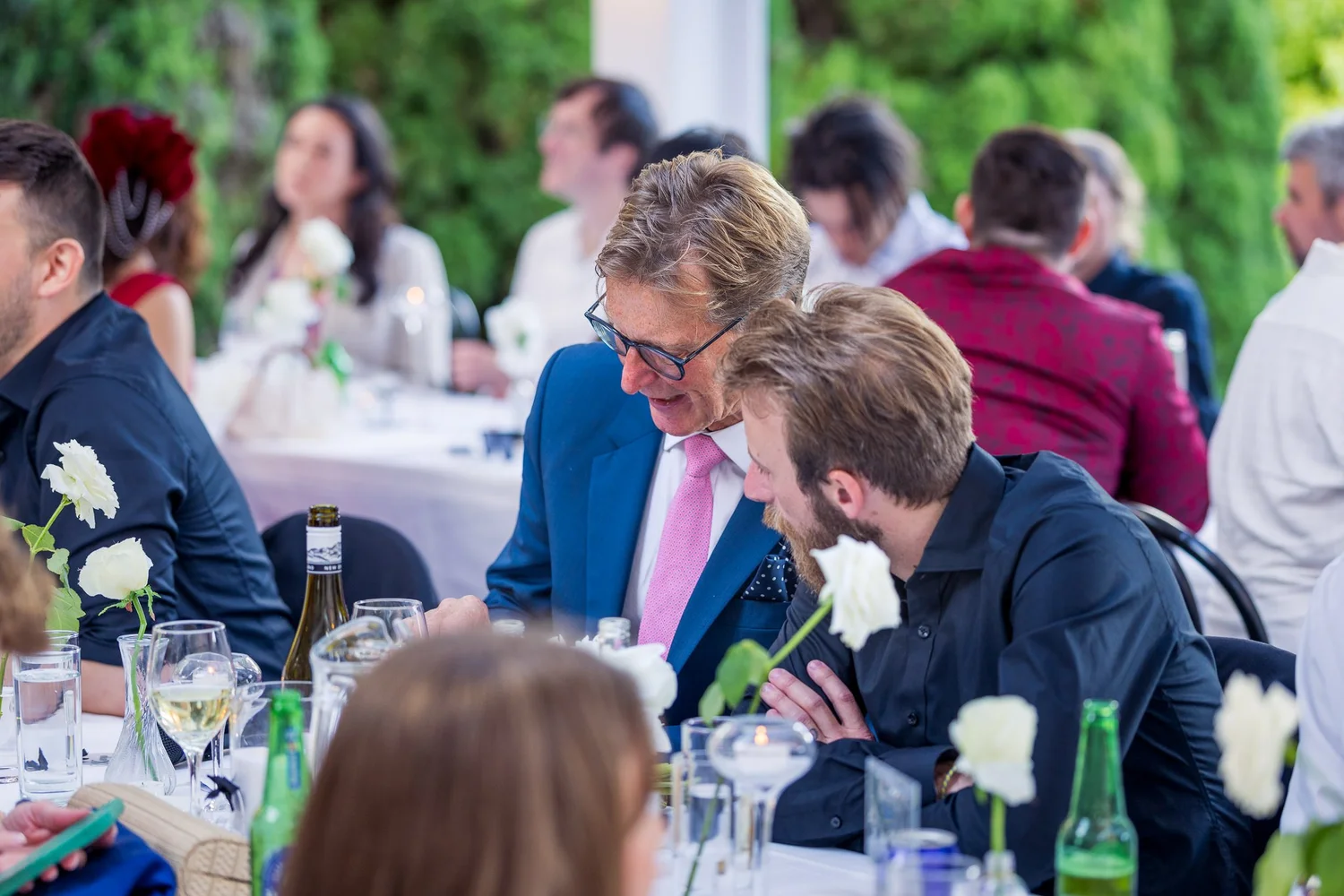 Guests laugh together at the reception