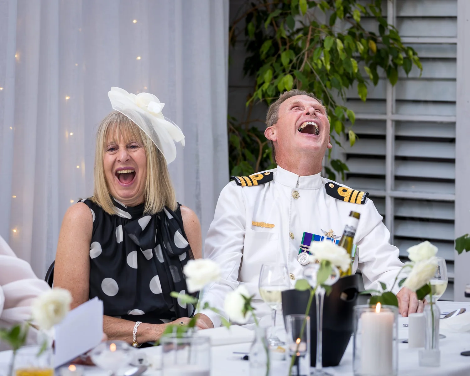 Two guests laugh during the speeches