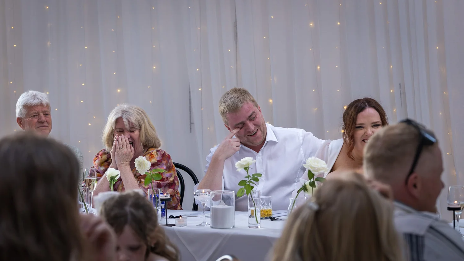 Guests enjoy the speeches at long reception tables