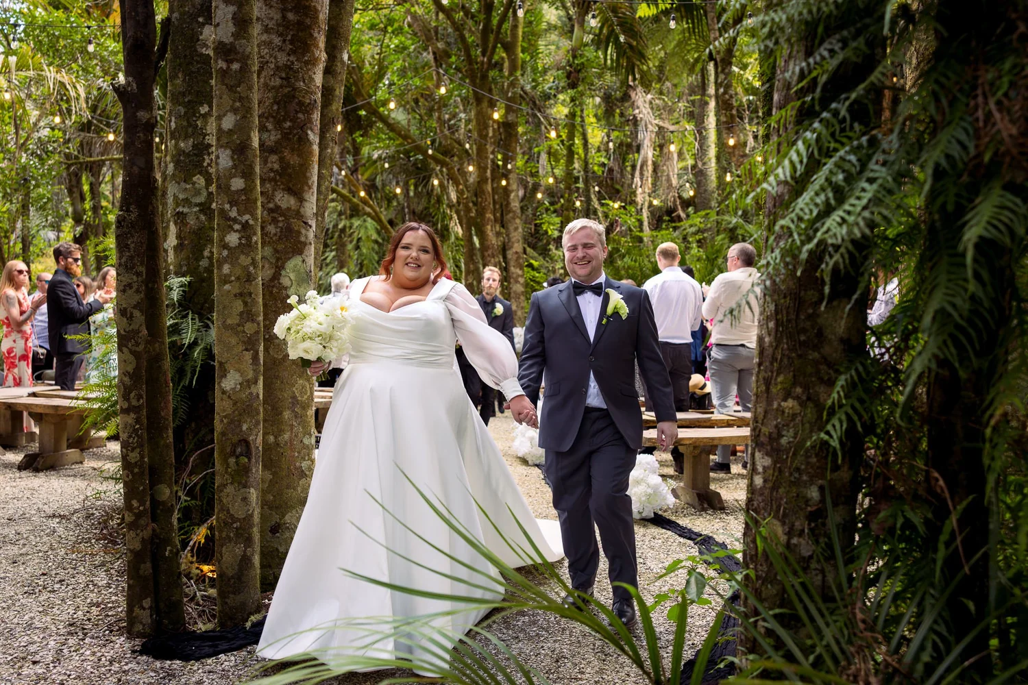 Leah and Warwick walk together through the native bush