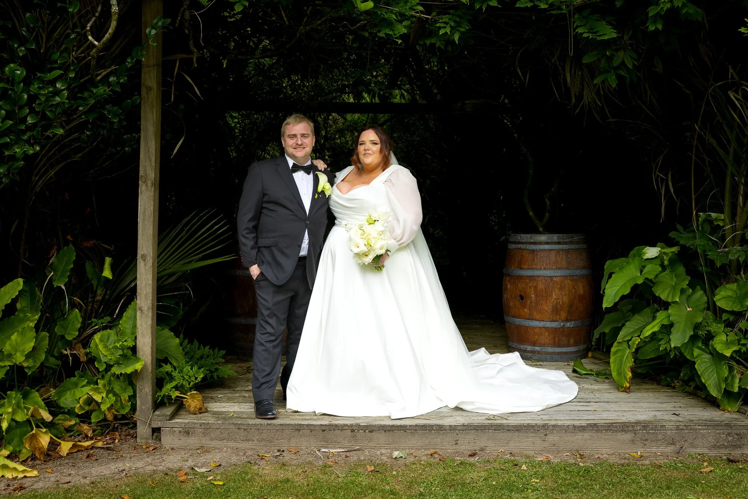 Leah and Warwick stand together in a garden clearing at Bridgewater Estate