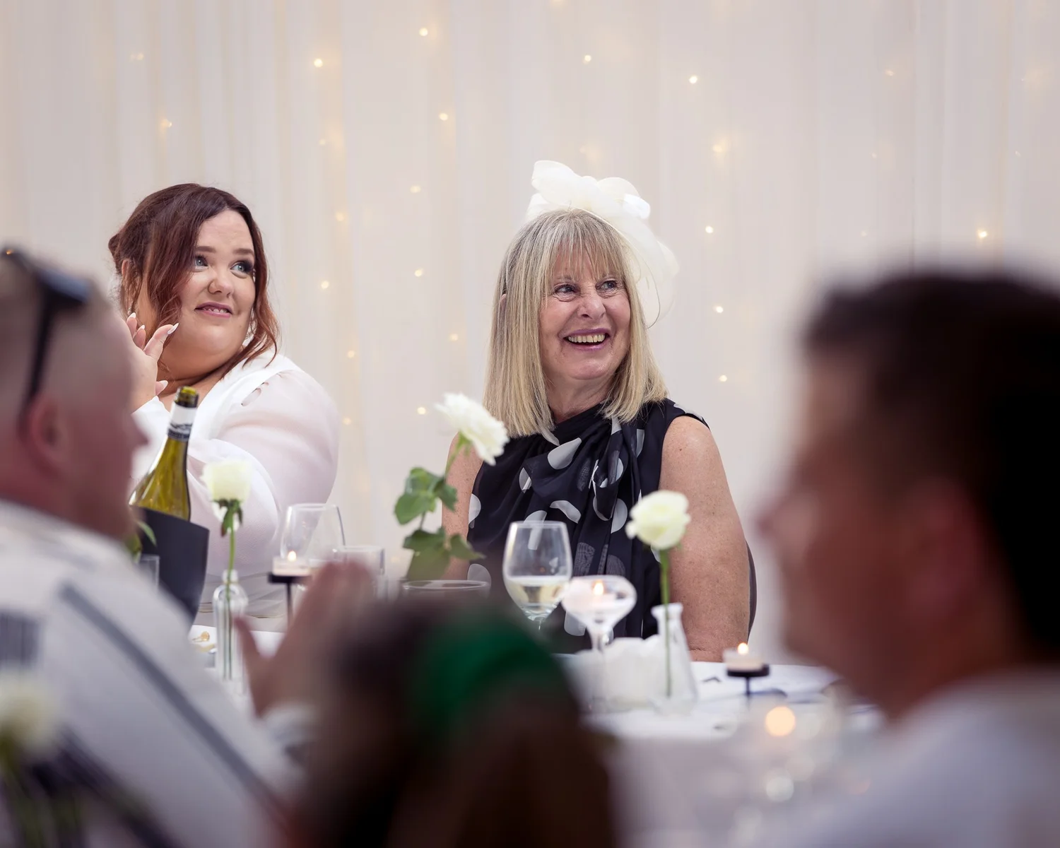 Two guests laugh during the speeches