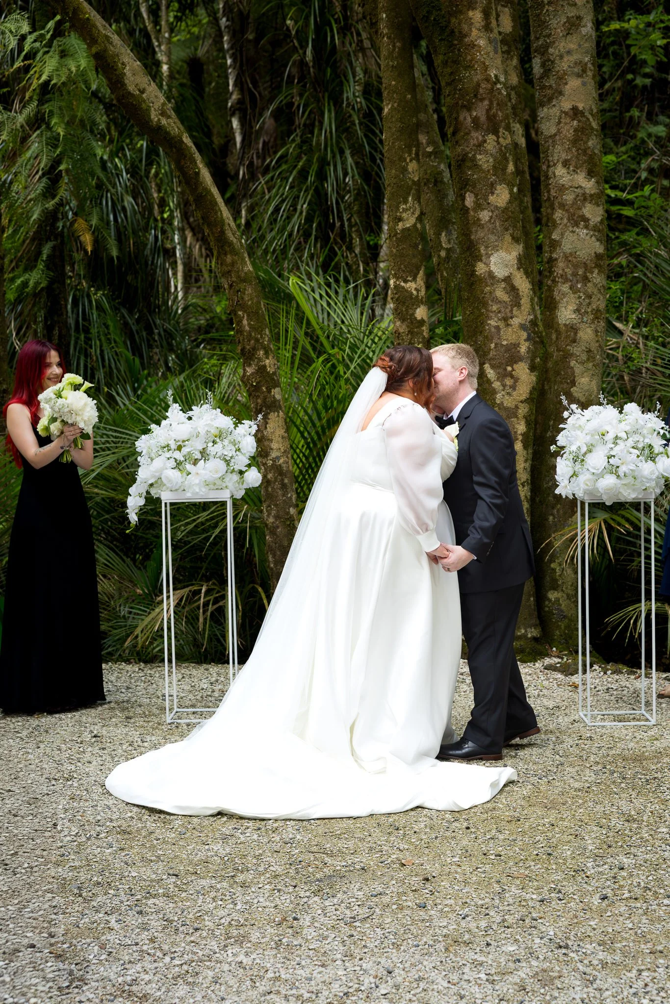 Leah and Warwick kiss at the end of their forest ceremony