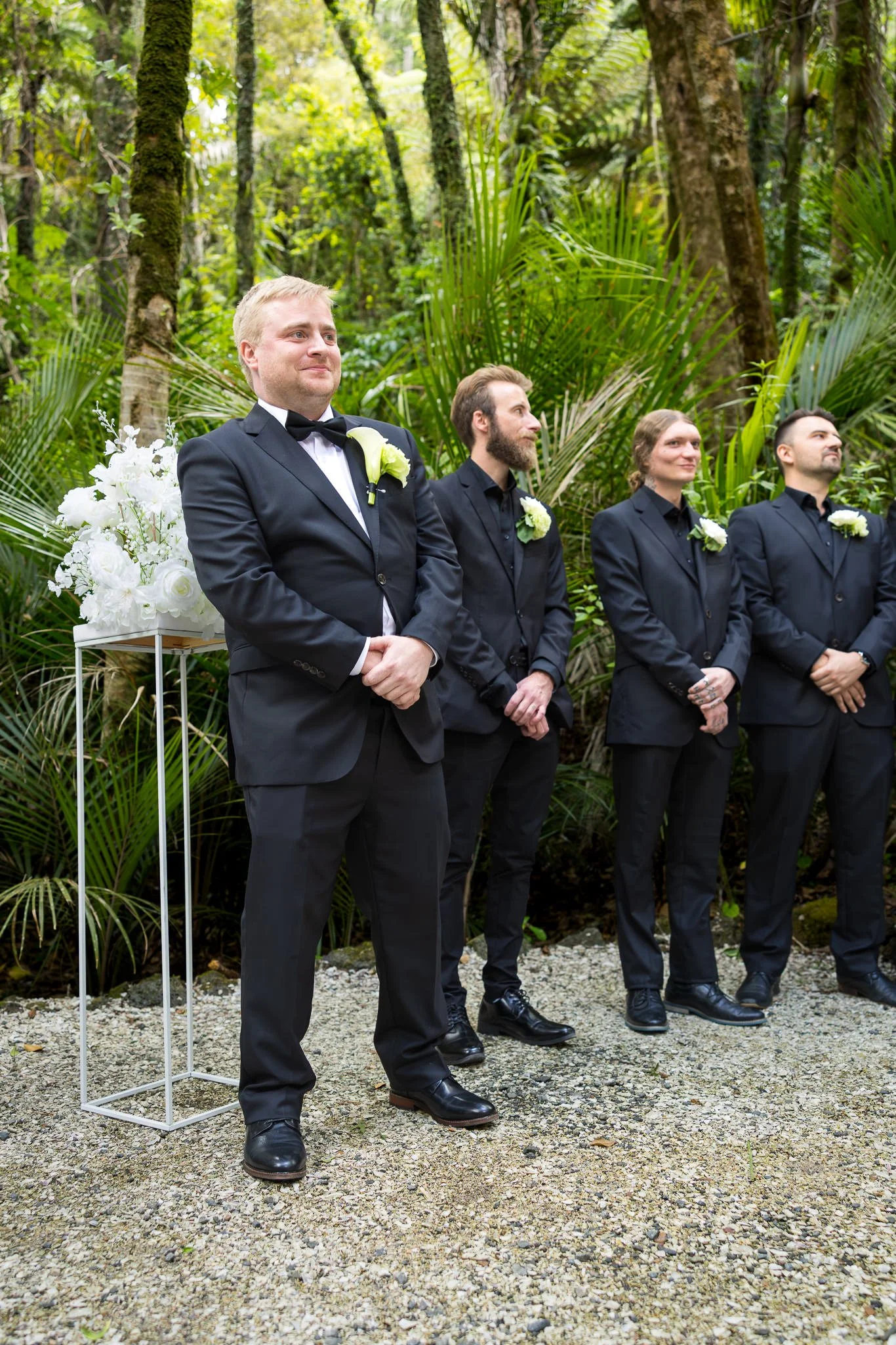 Warwick and his groomsmen wait among the trees for the ceremony