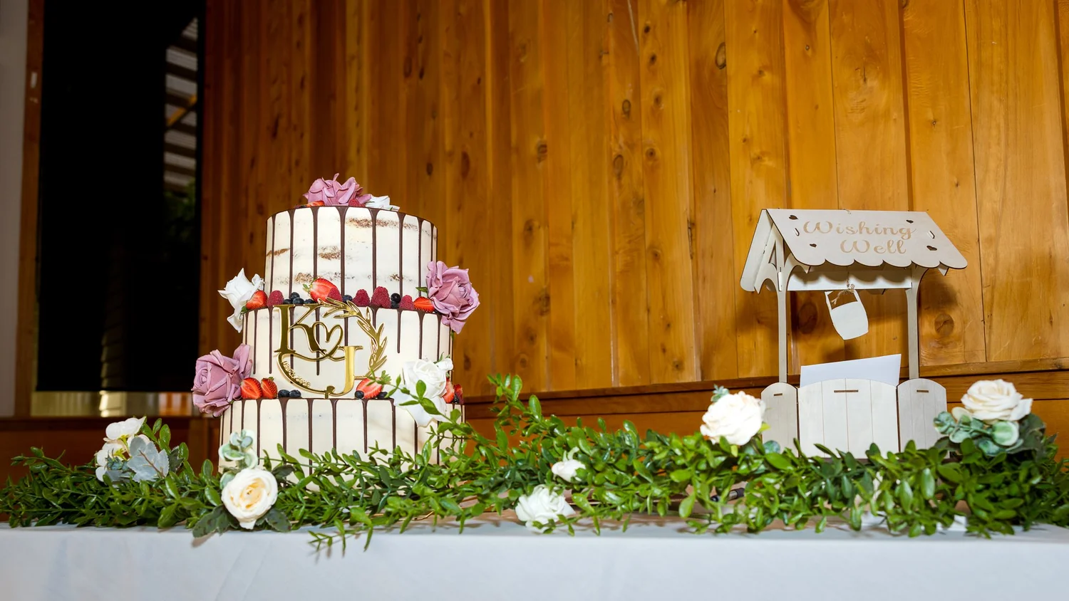 The wedding cake decorated with pink flowers