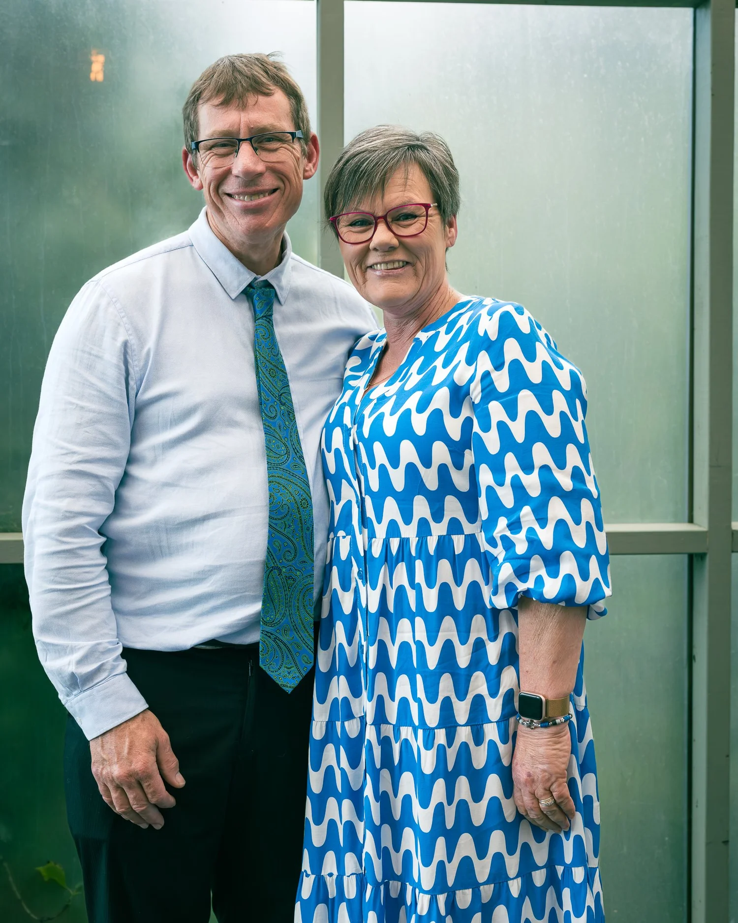 Two guests smile together for a portrait