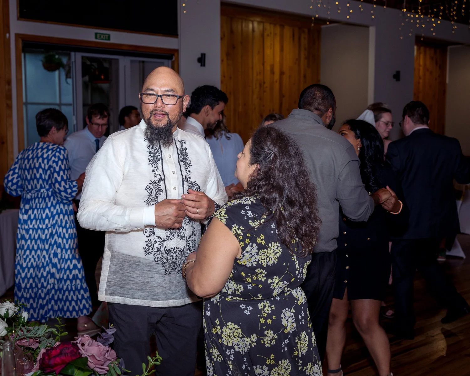 A guest dances in an embroidered barong shirt