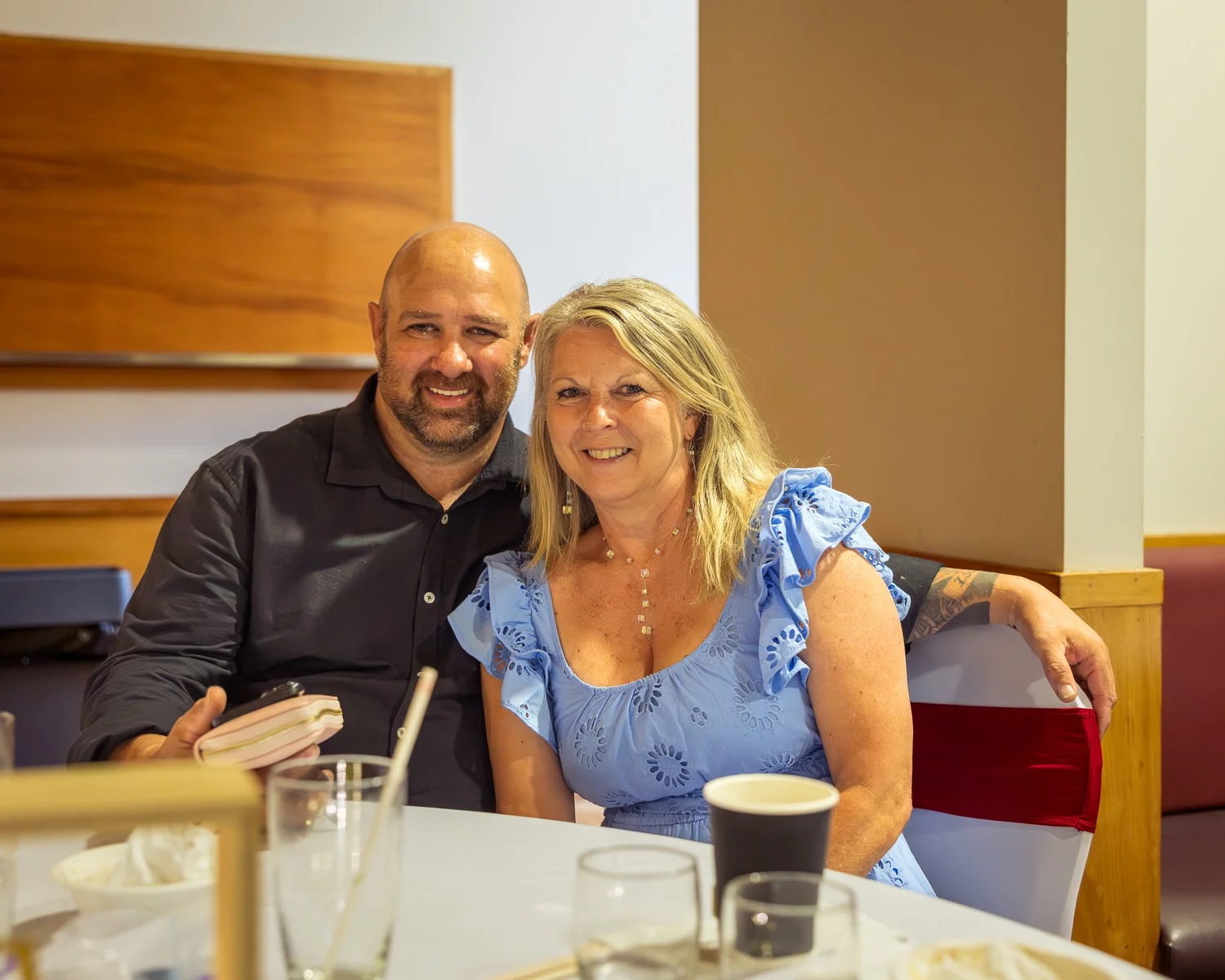 Two guests smile at their table