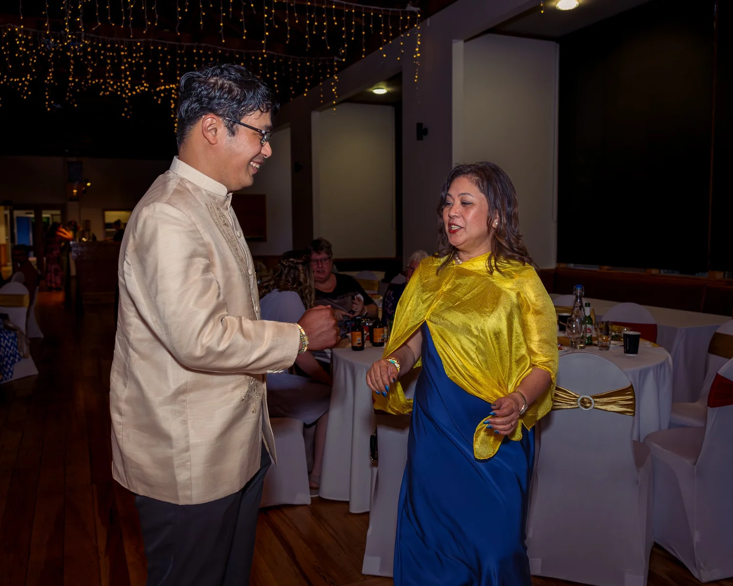 Two guests dance at the reception