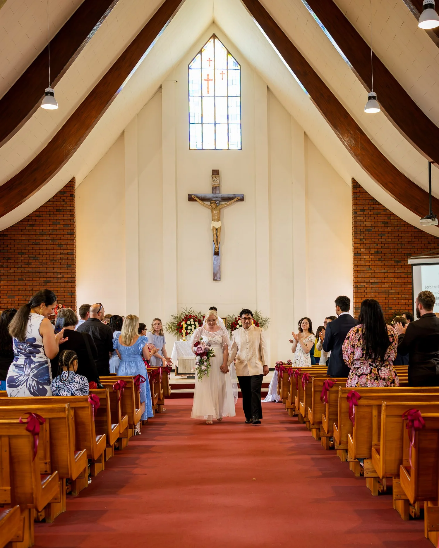 Kirstin and Justin walk back down the aisle as husband and wife
