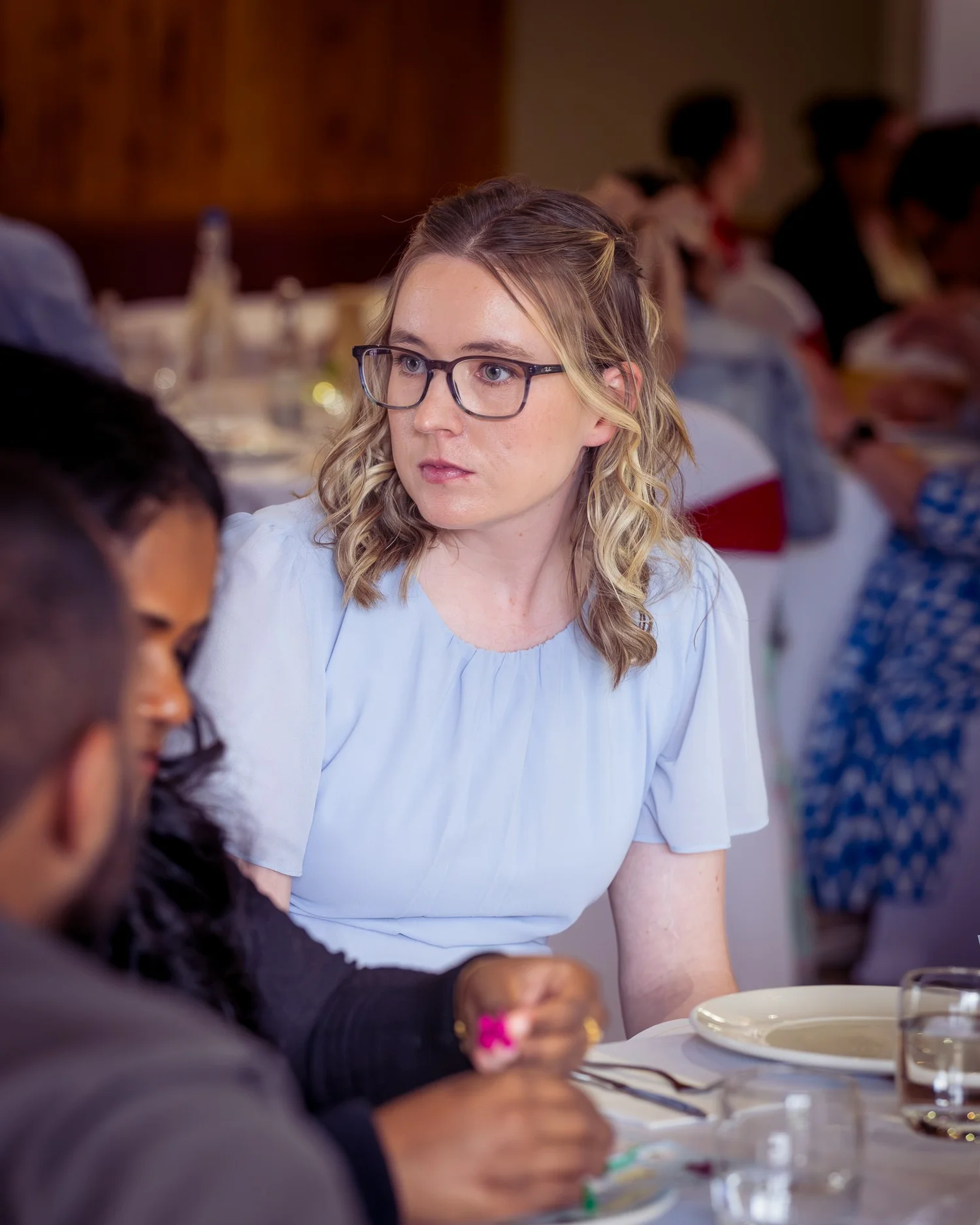 A guest in glasses smiles at the reception