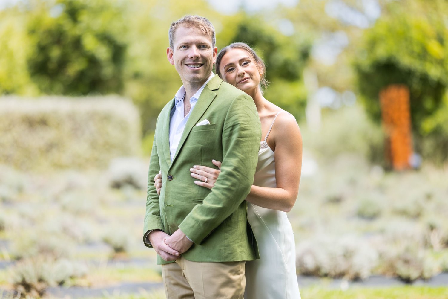 Jade and Ben smile together in the garden