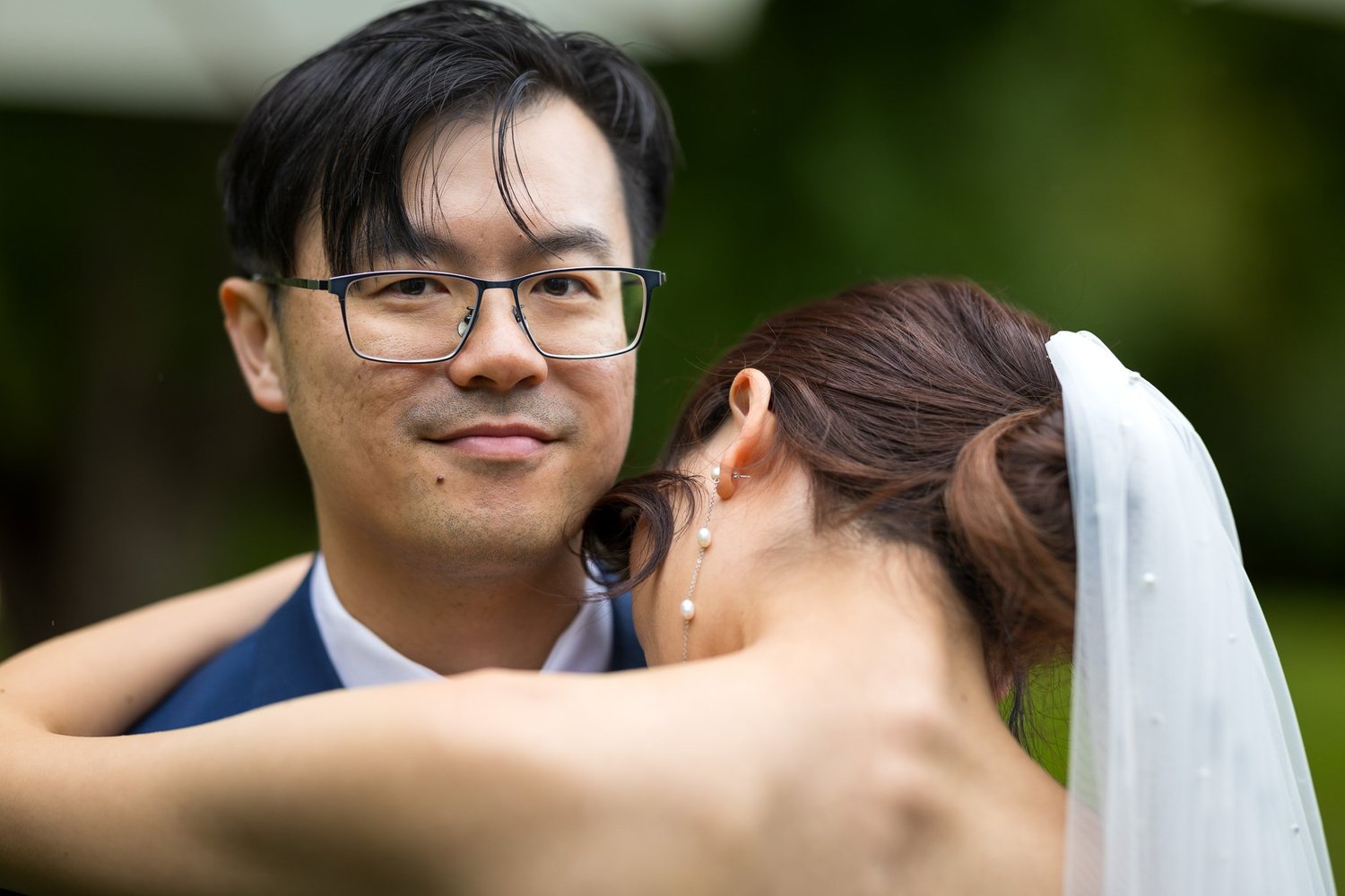 Chi smiles as Cherry rests her head against his shoulder