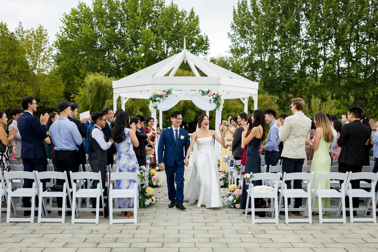 Cherry and Chi walk back up the aisle past their guests at Abel Estate